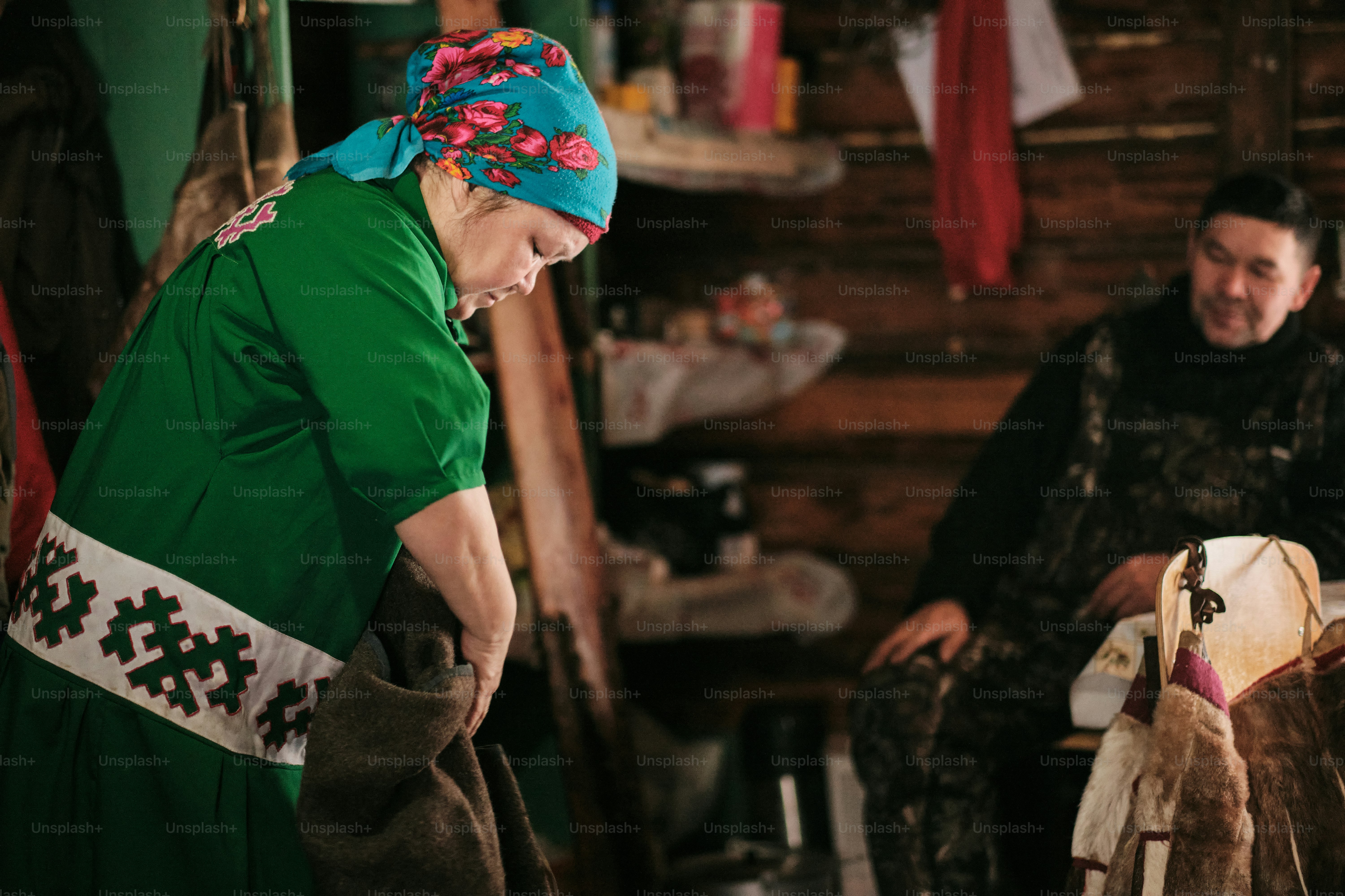A woman in a green shirt standing next to a man in a green shirt