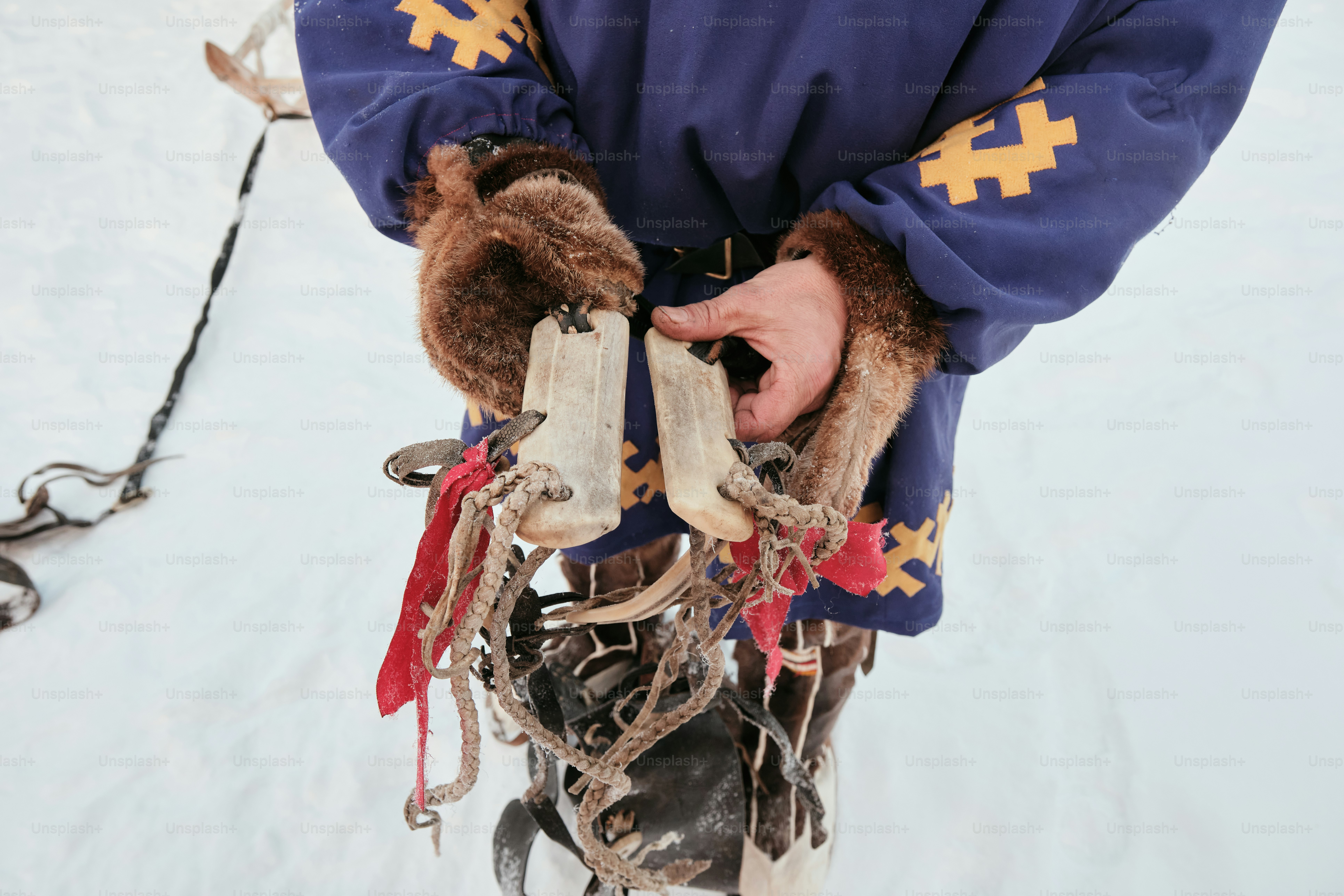 A man holding a pair of skis in his hands