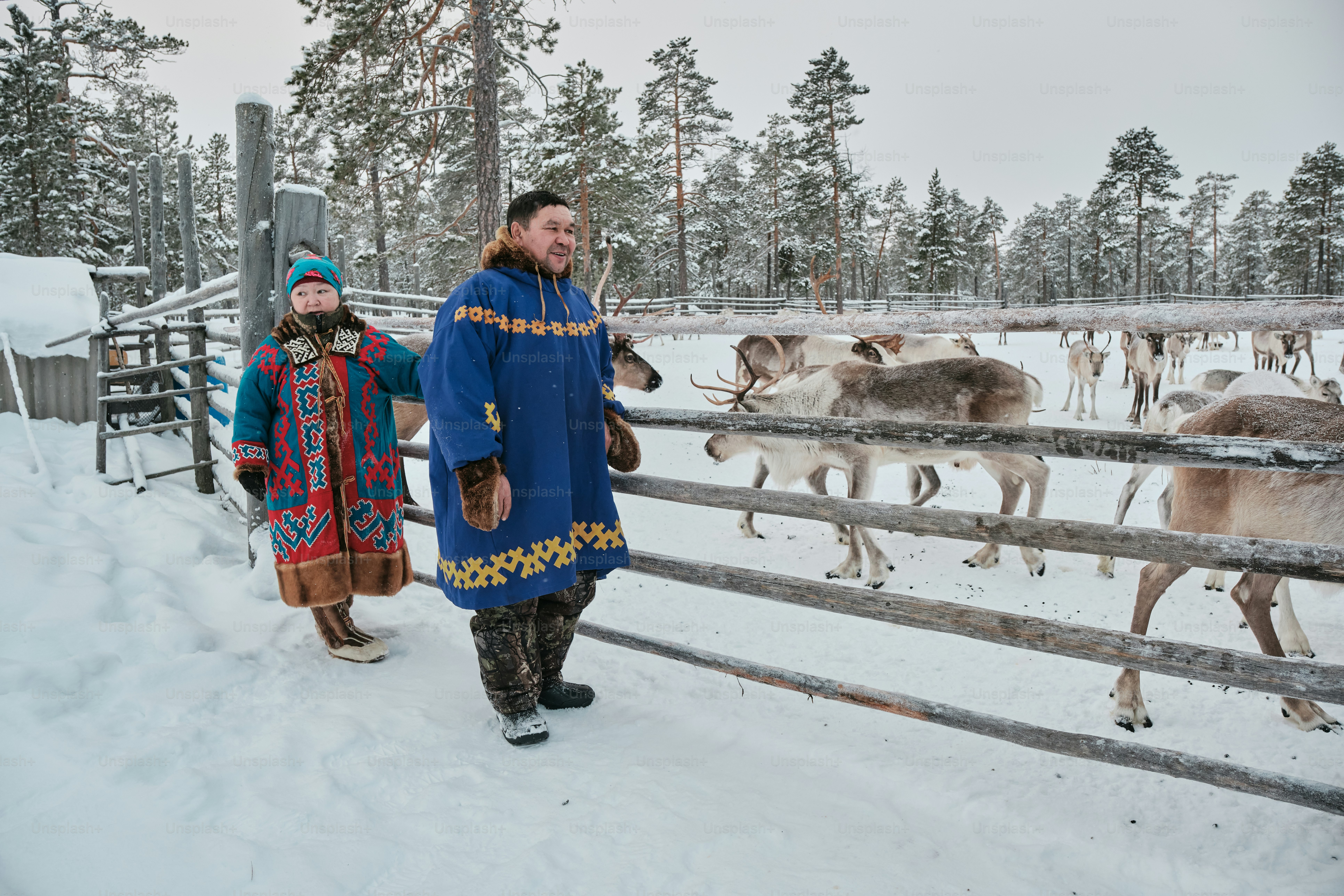 A couple of people that are standing in the snow