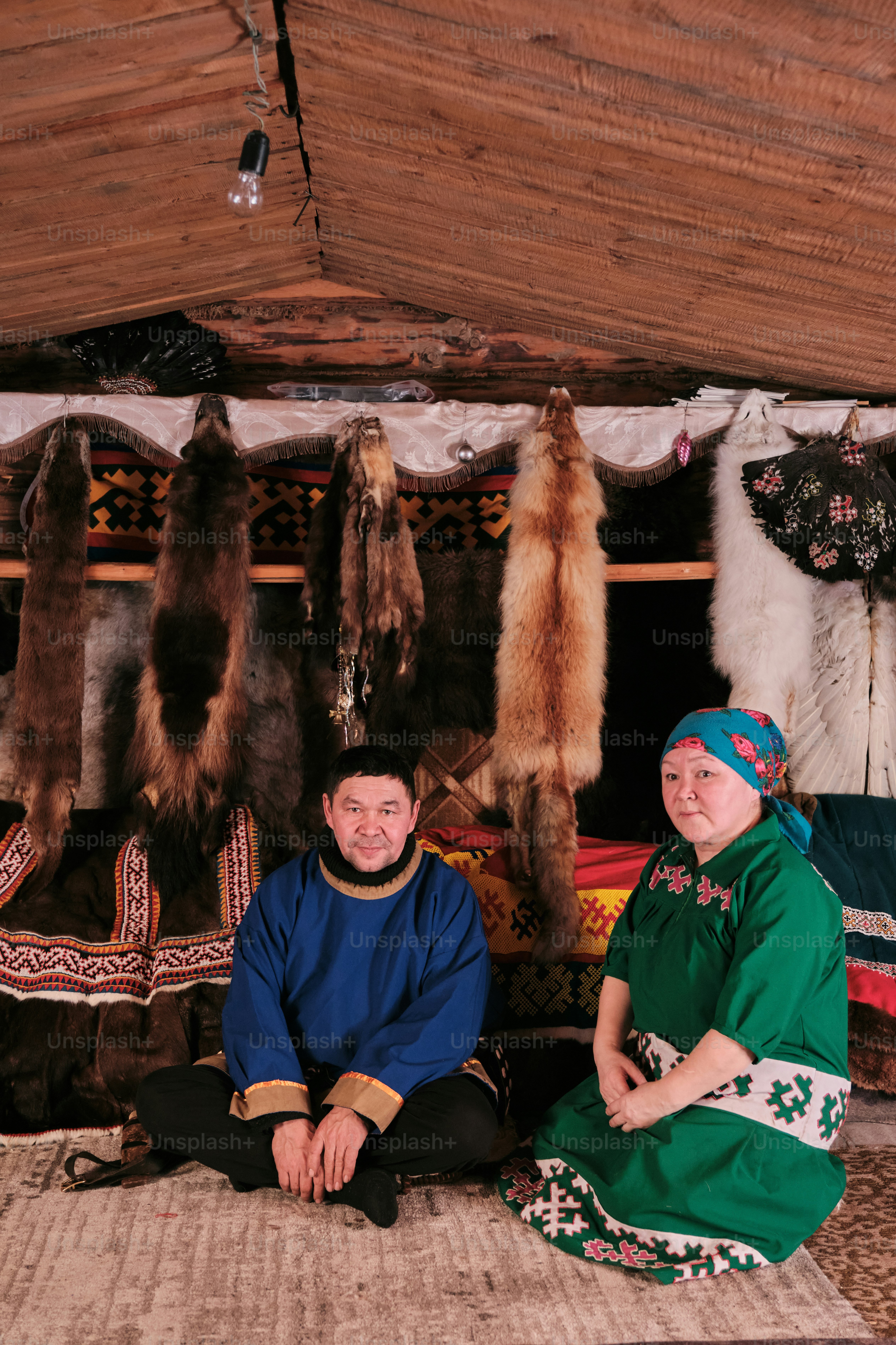 A couple of people sitting on a rug in a room