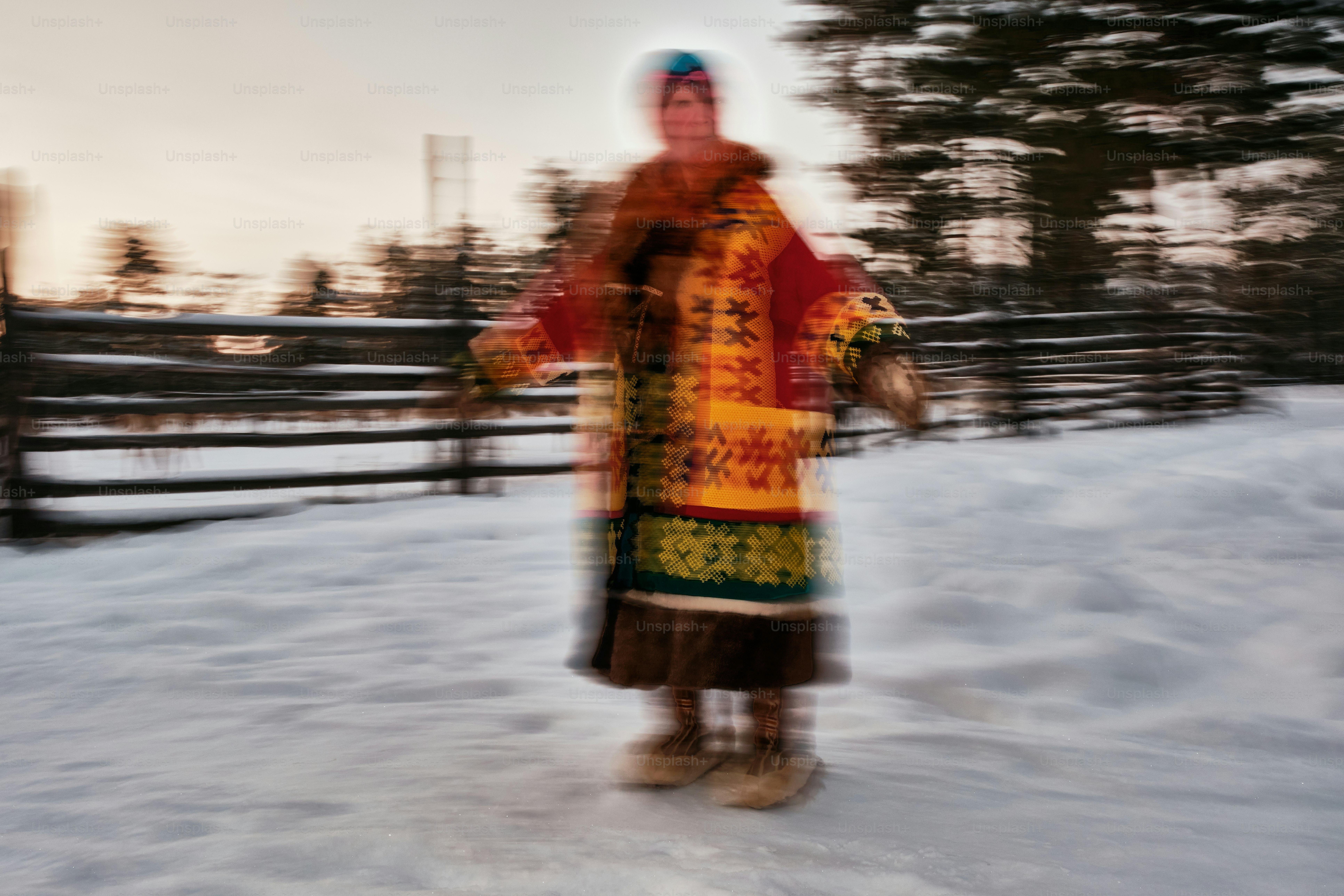 A blurry photo of a person standing in the snow