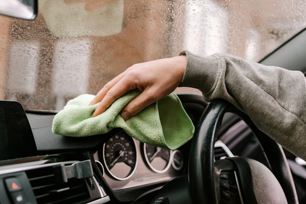 Car interior dashboard and steering wheel cleaning with microfiber cloth in Bangalore