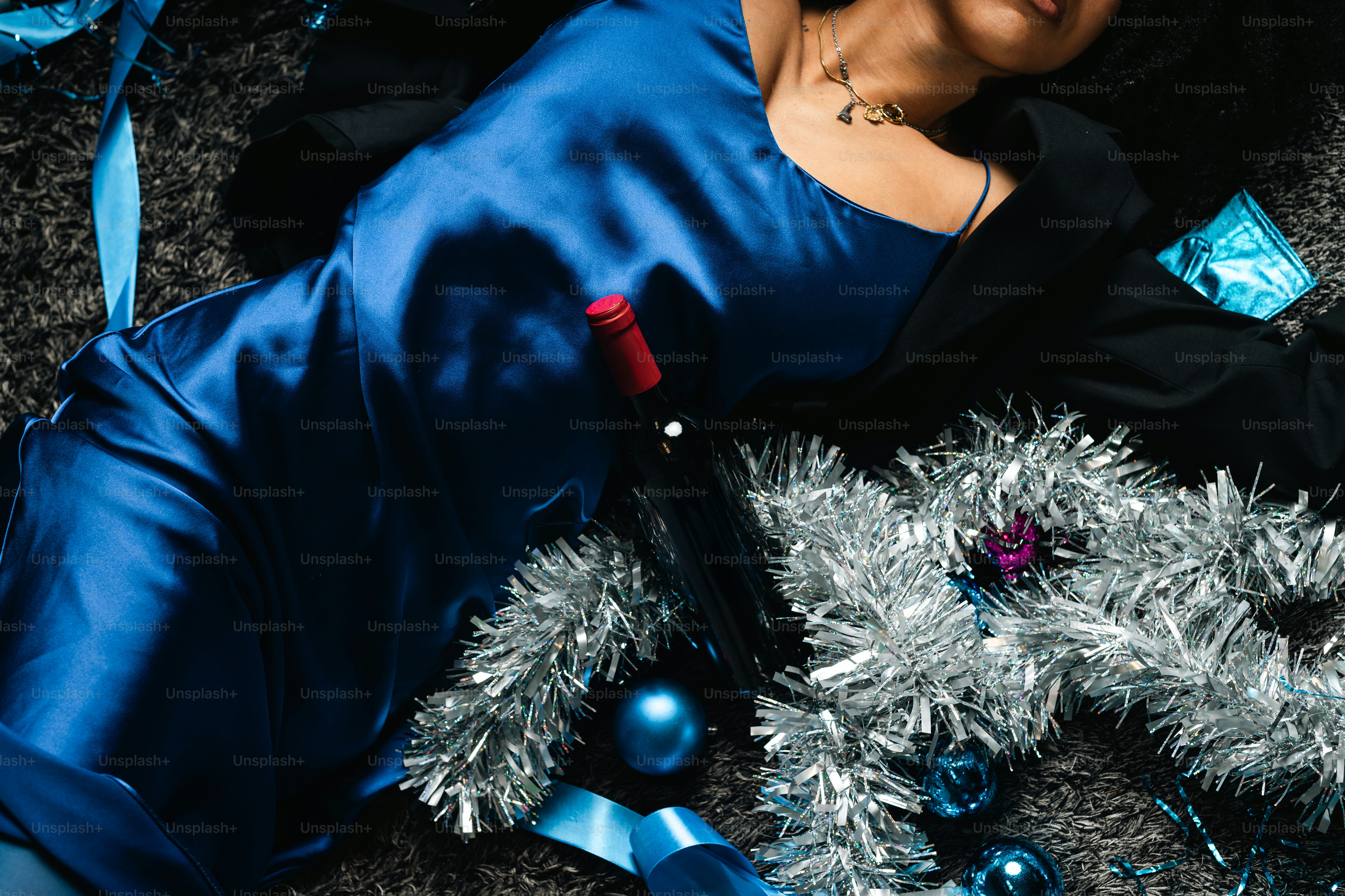 A woman in a blue dress laying on the ground