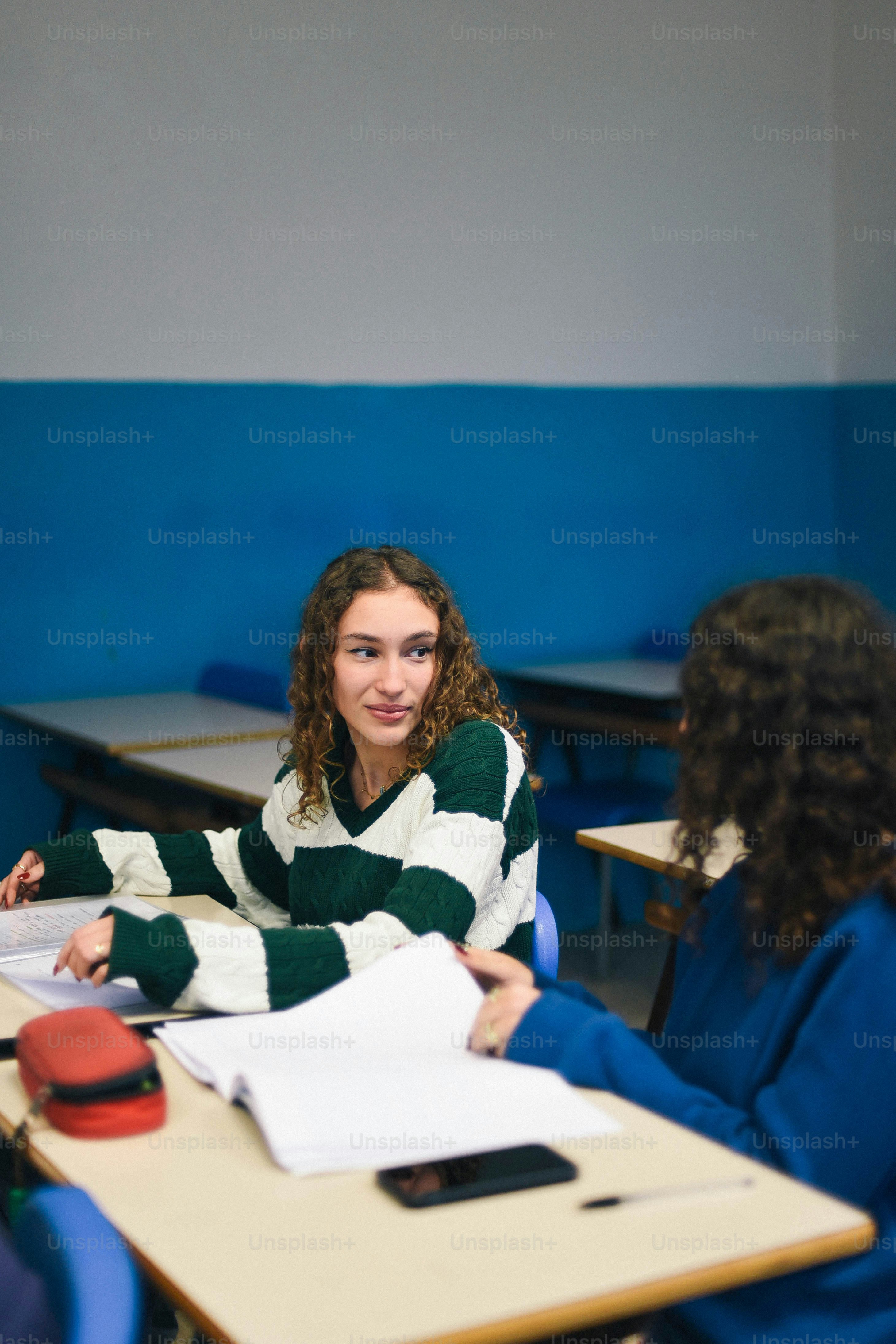 A group of girls sitting at desks in a classroom