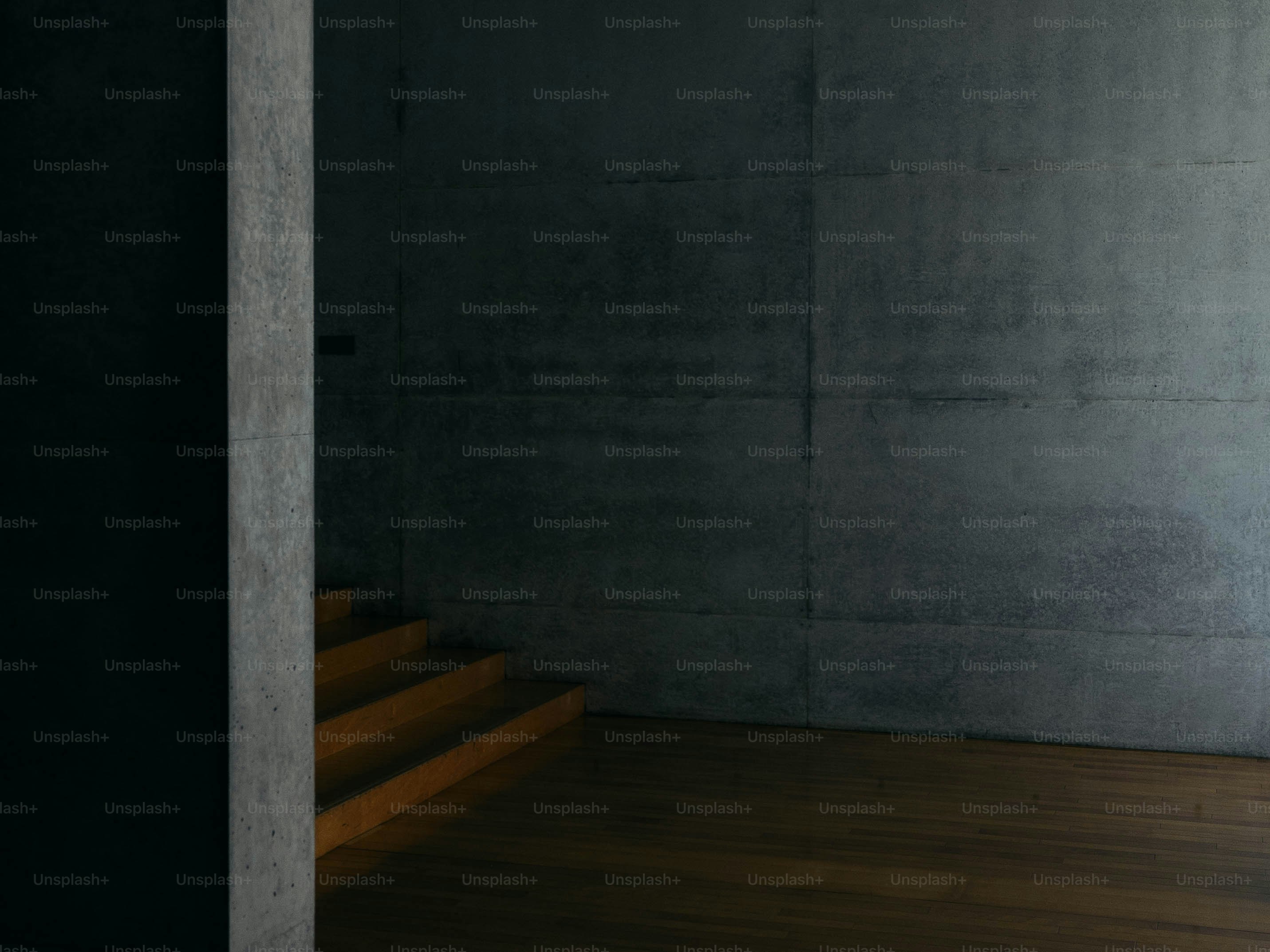 A man in a suit and tie standing in front of a wall