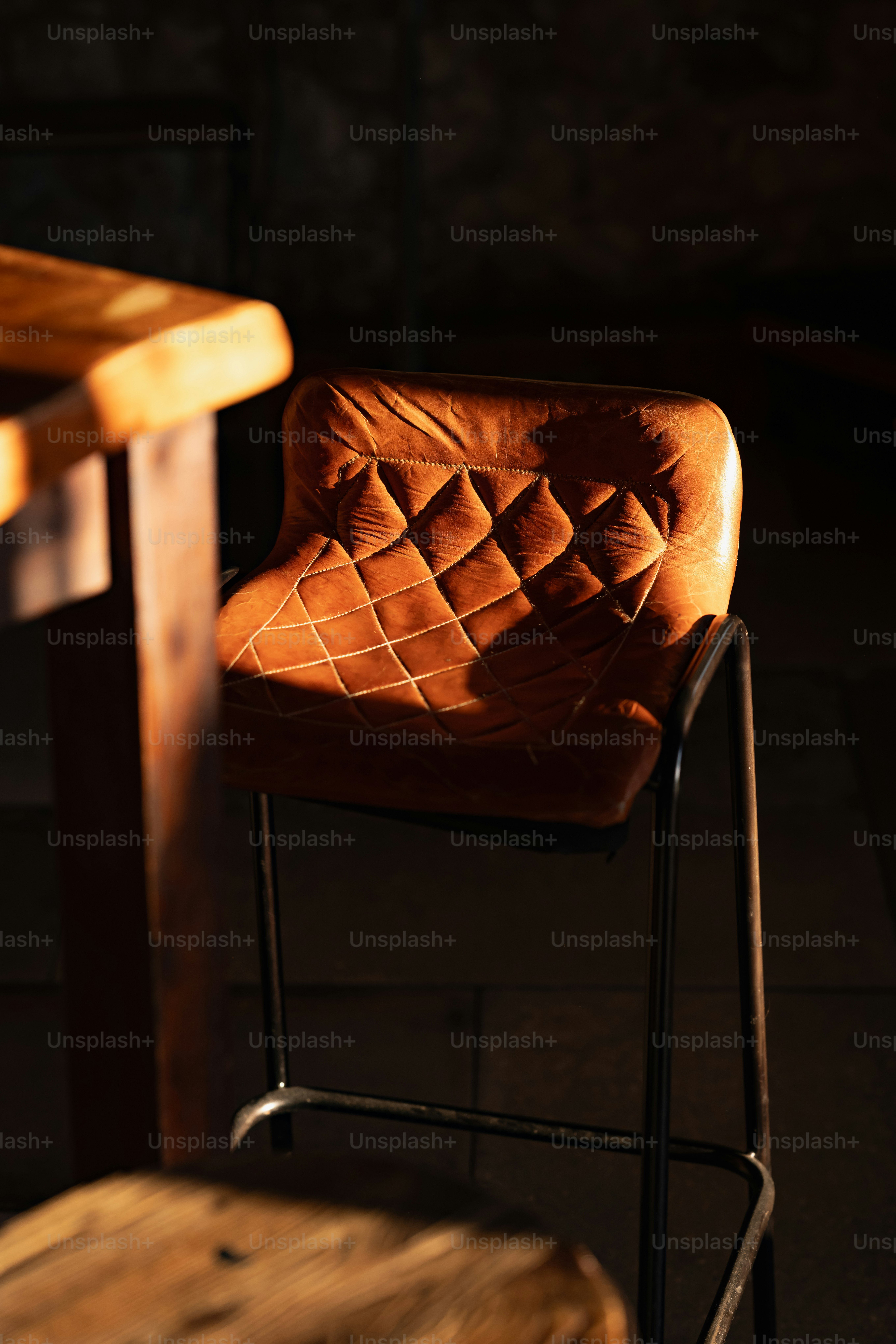 A brown chair sitting next to a wooden table