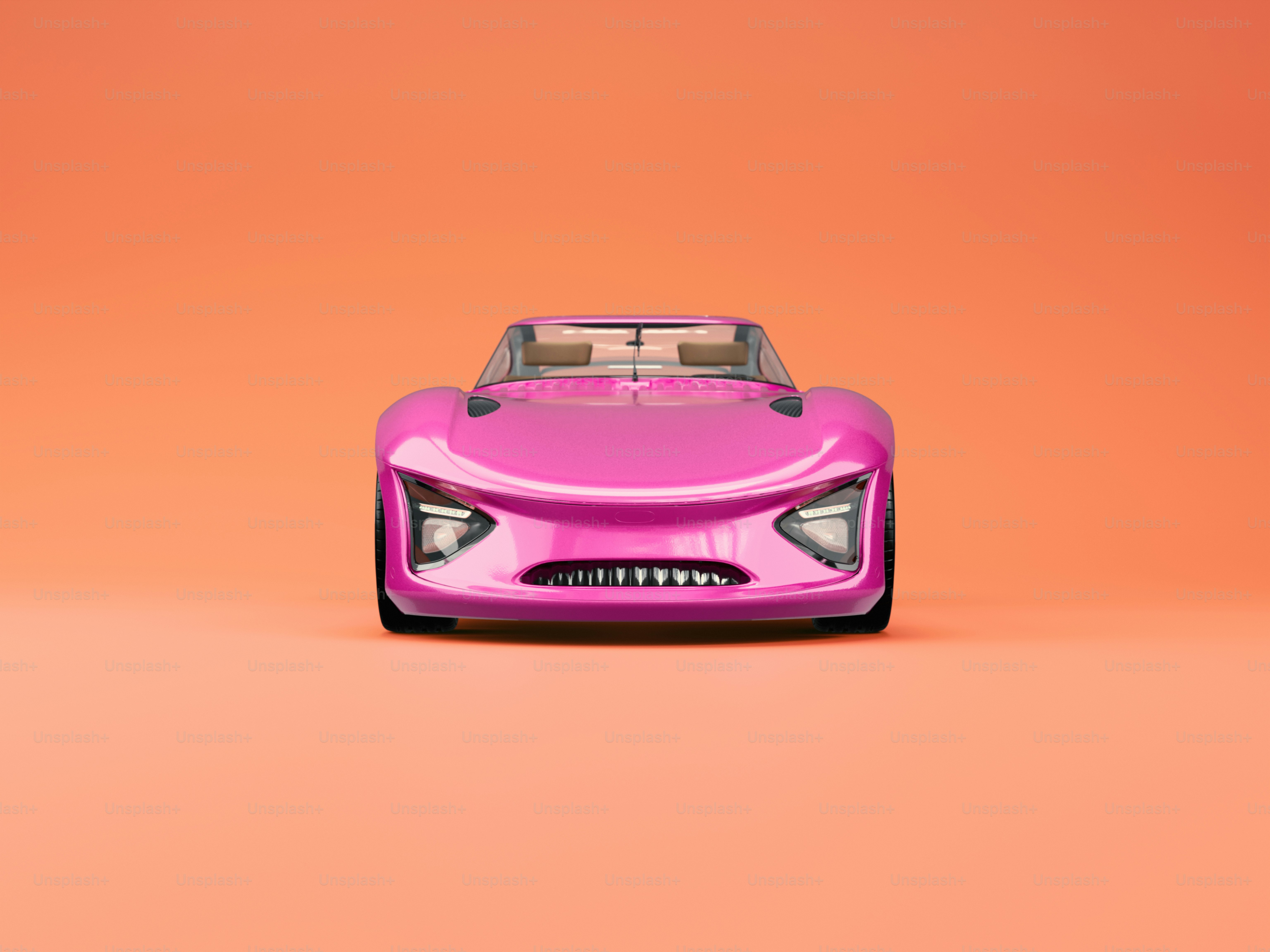 オレンジの背景にピンクのおもちゃの車