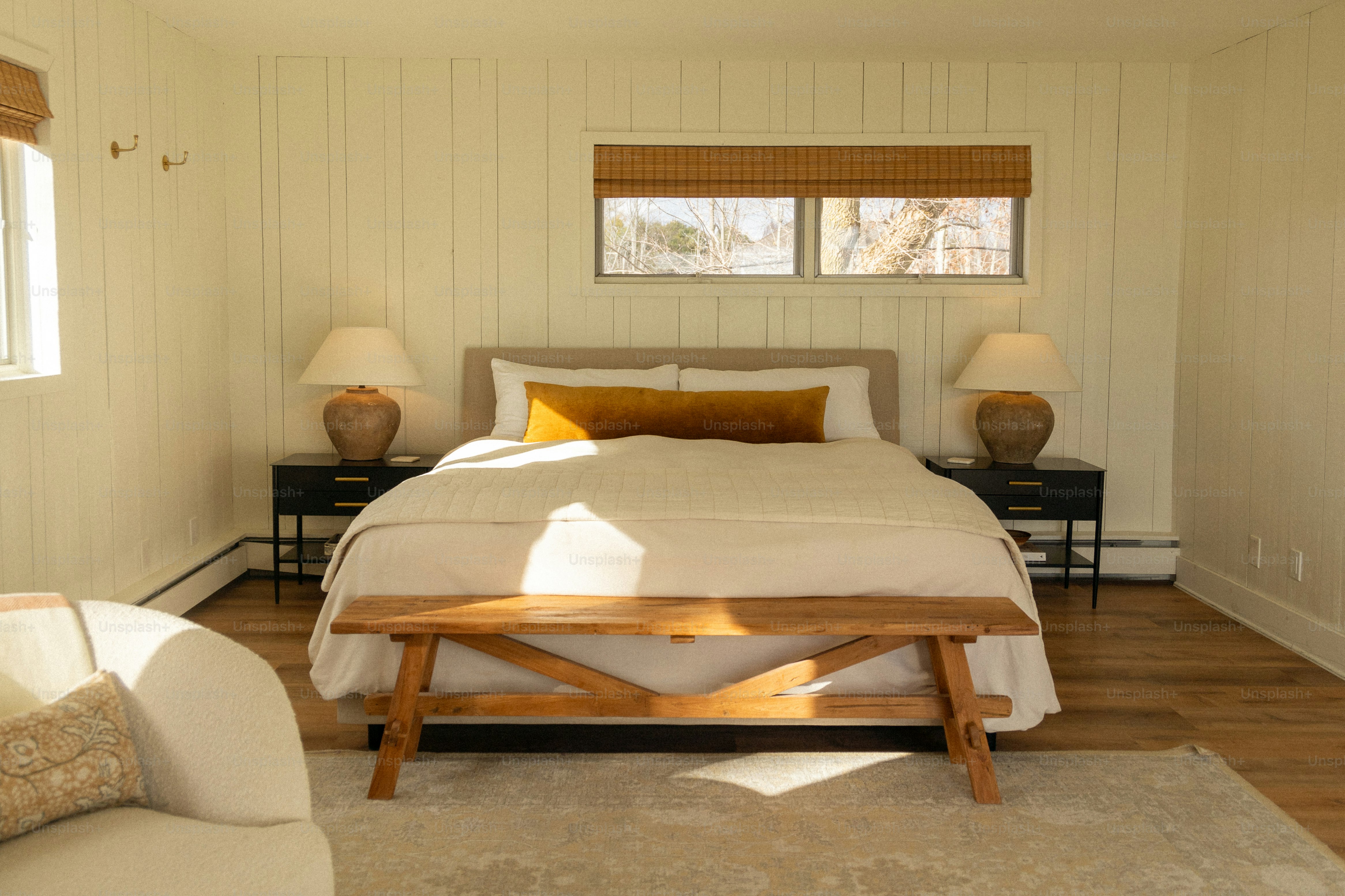 A bed sitting in a bedroom next to a window