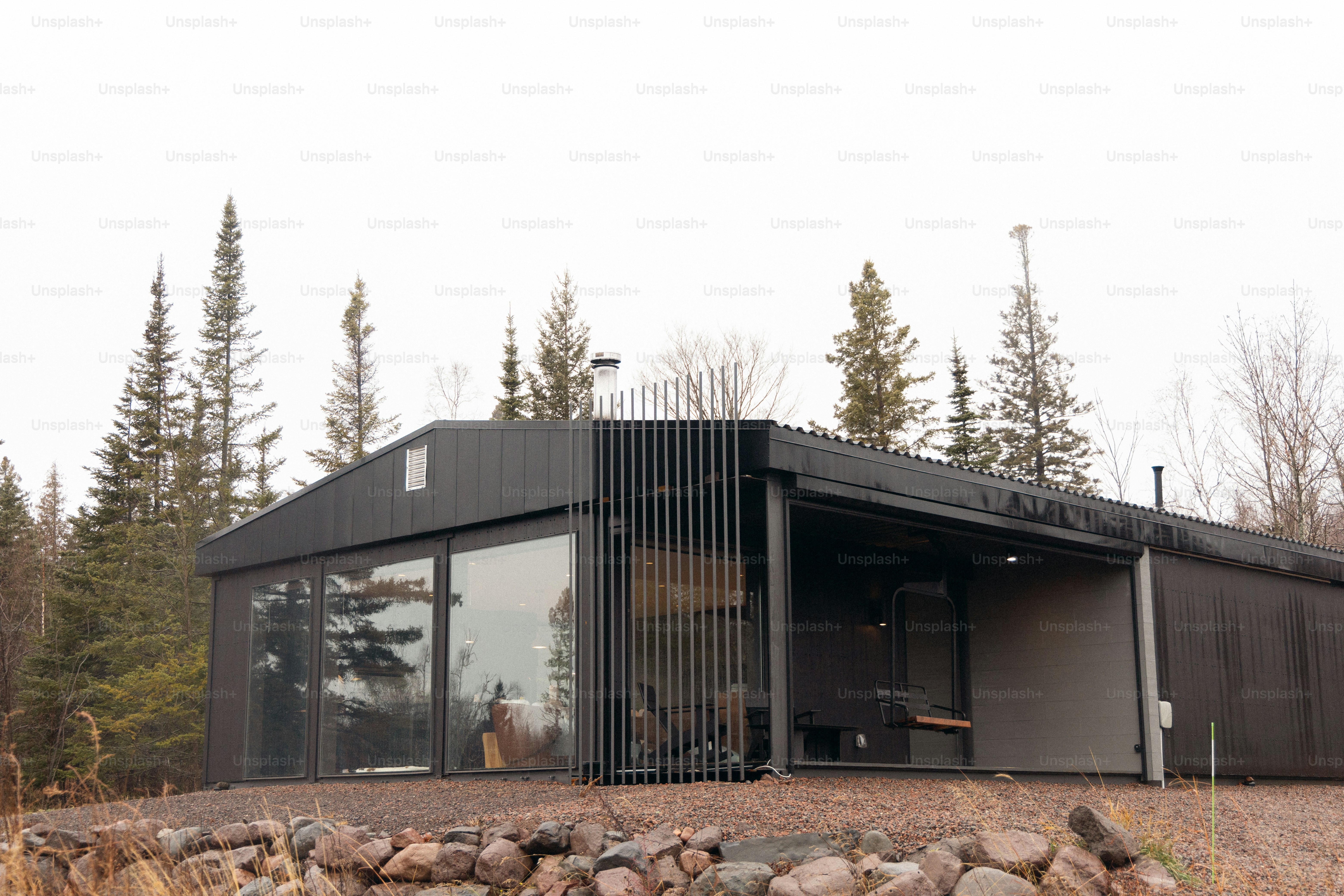 A small black house sitting on top of a hill