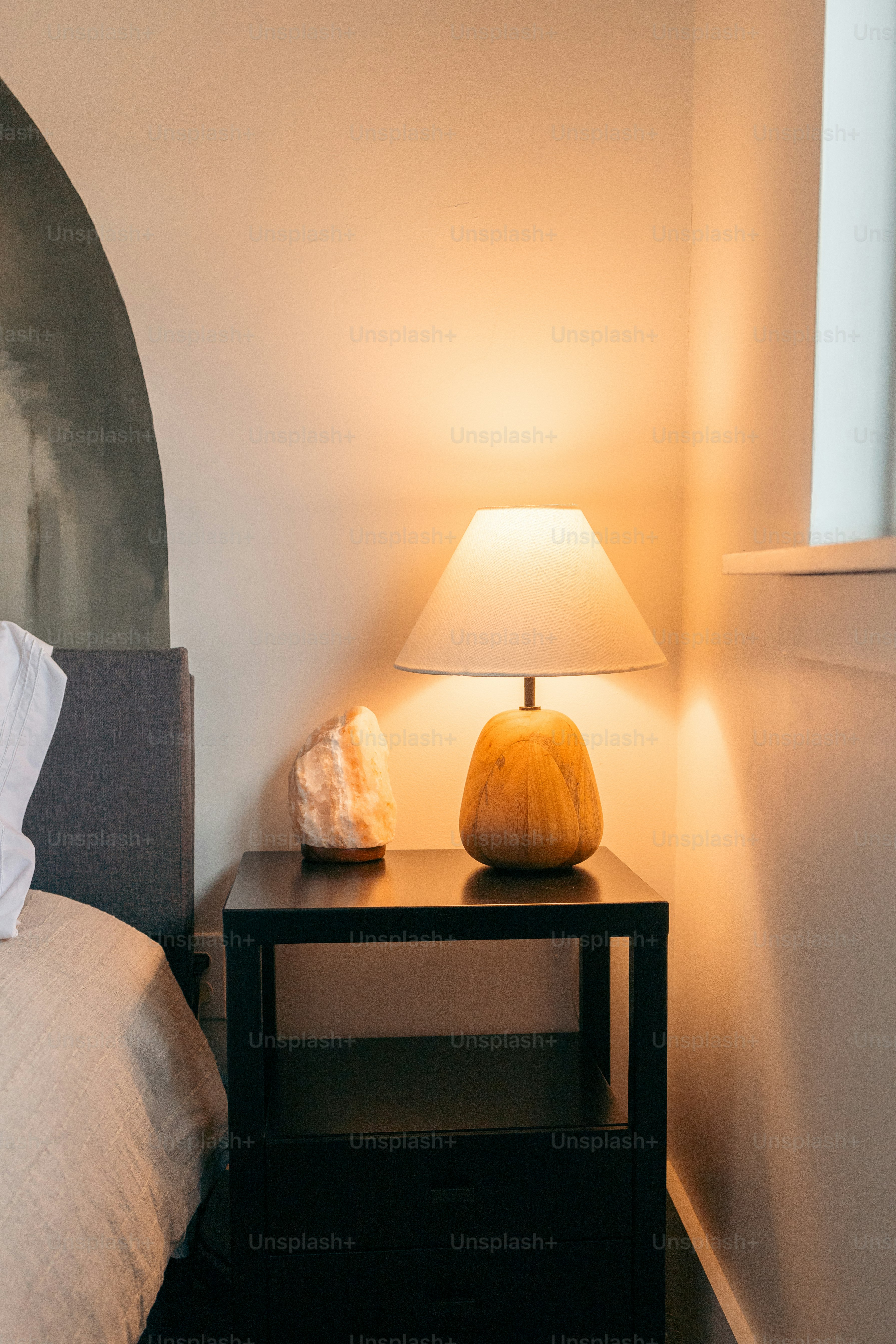 A bedroom with a bed and a night stand