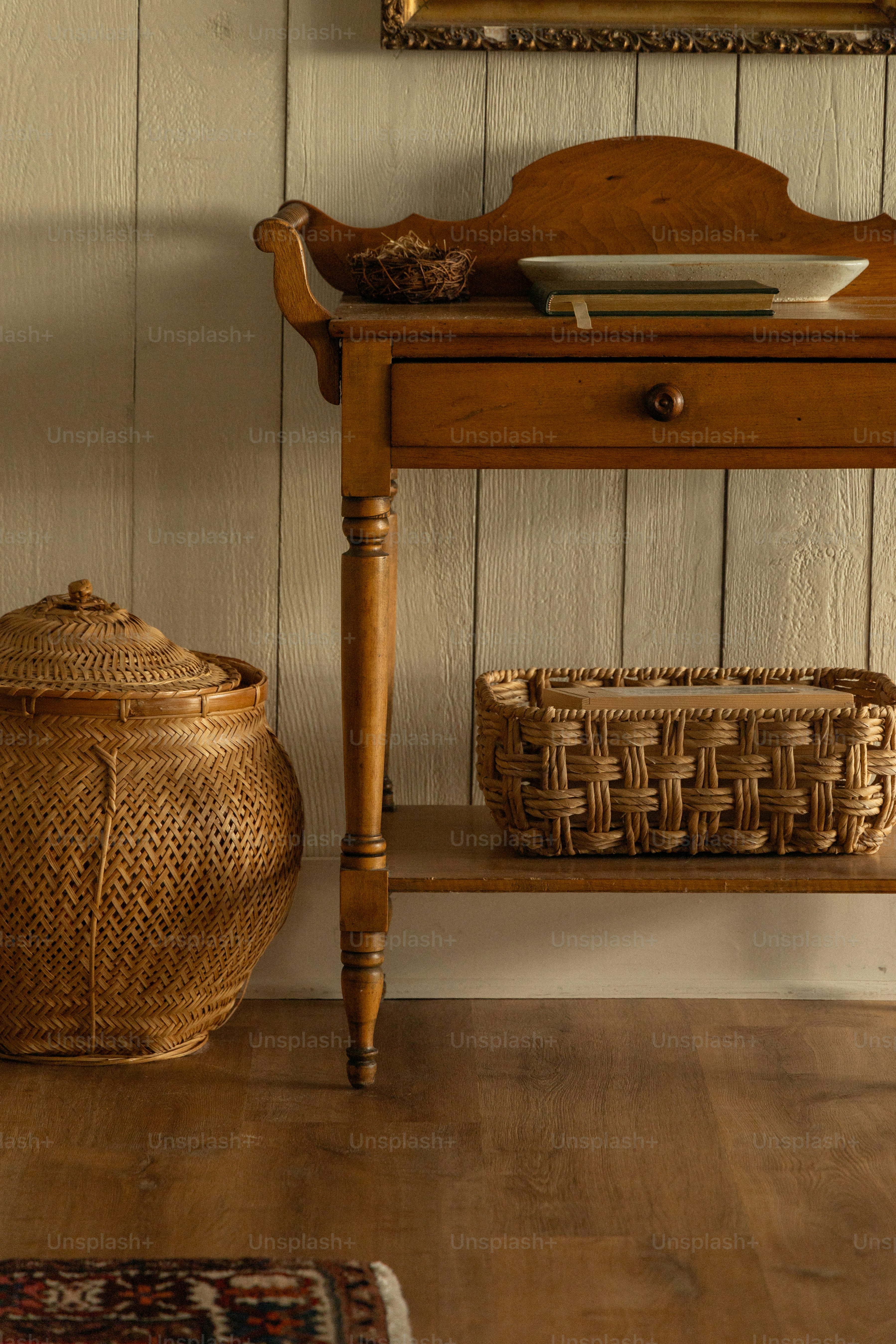 A wooden table with a basket on top of it