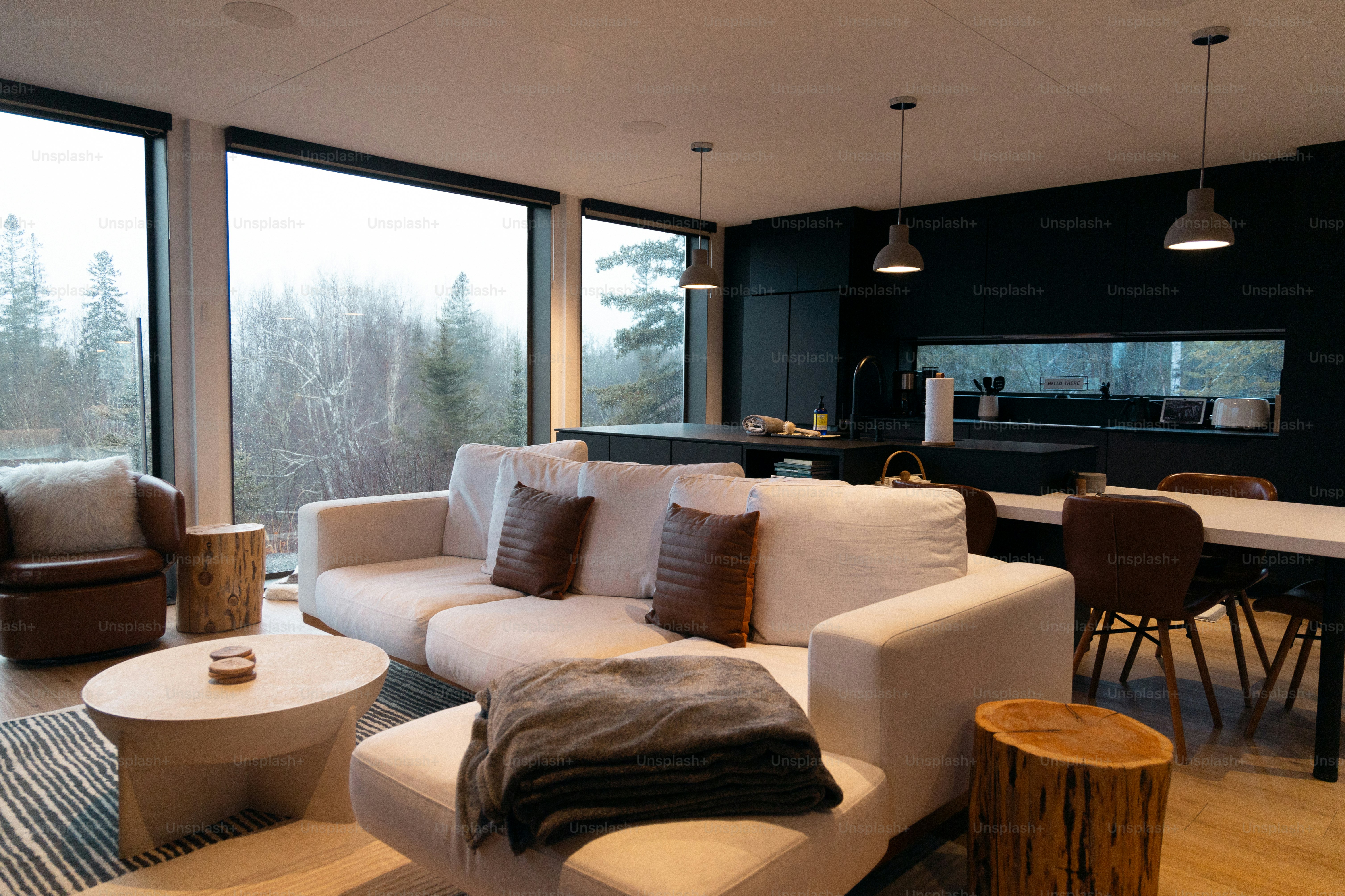 A living room filled with furniture and large windows