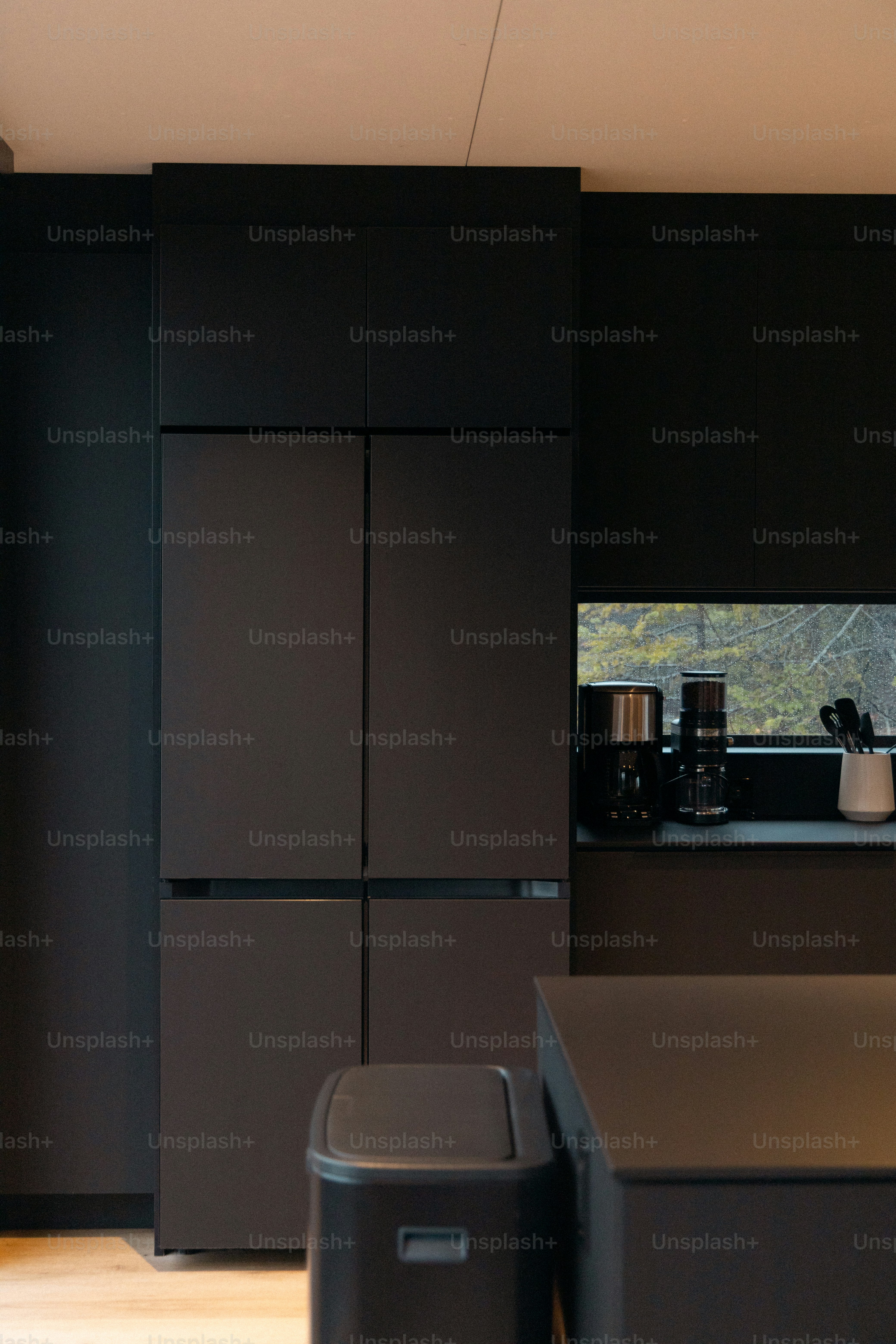 A kitchen with black cabinets and a counter top