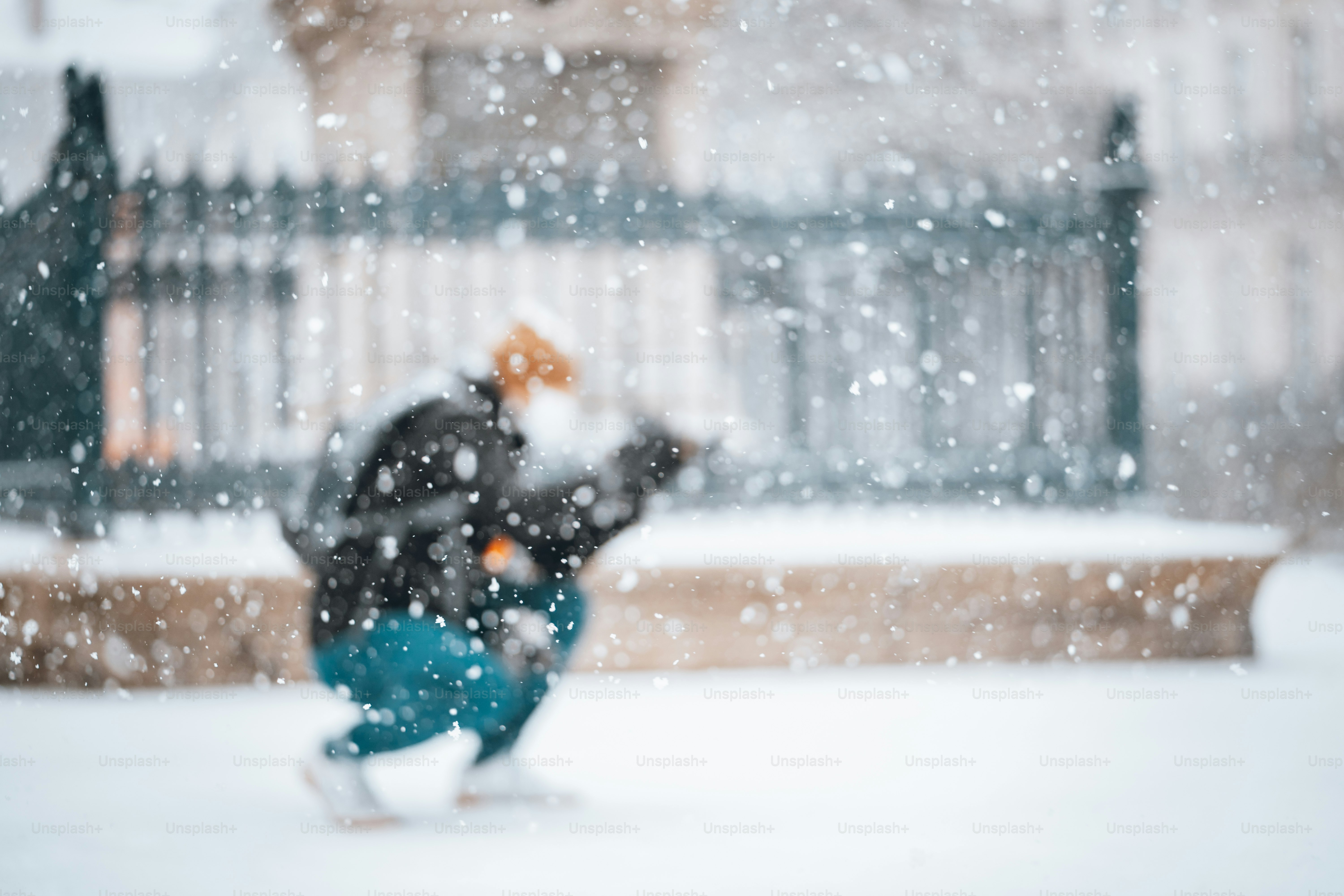 A man is running through the snow in the city photo – City Image on ...