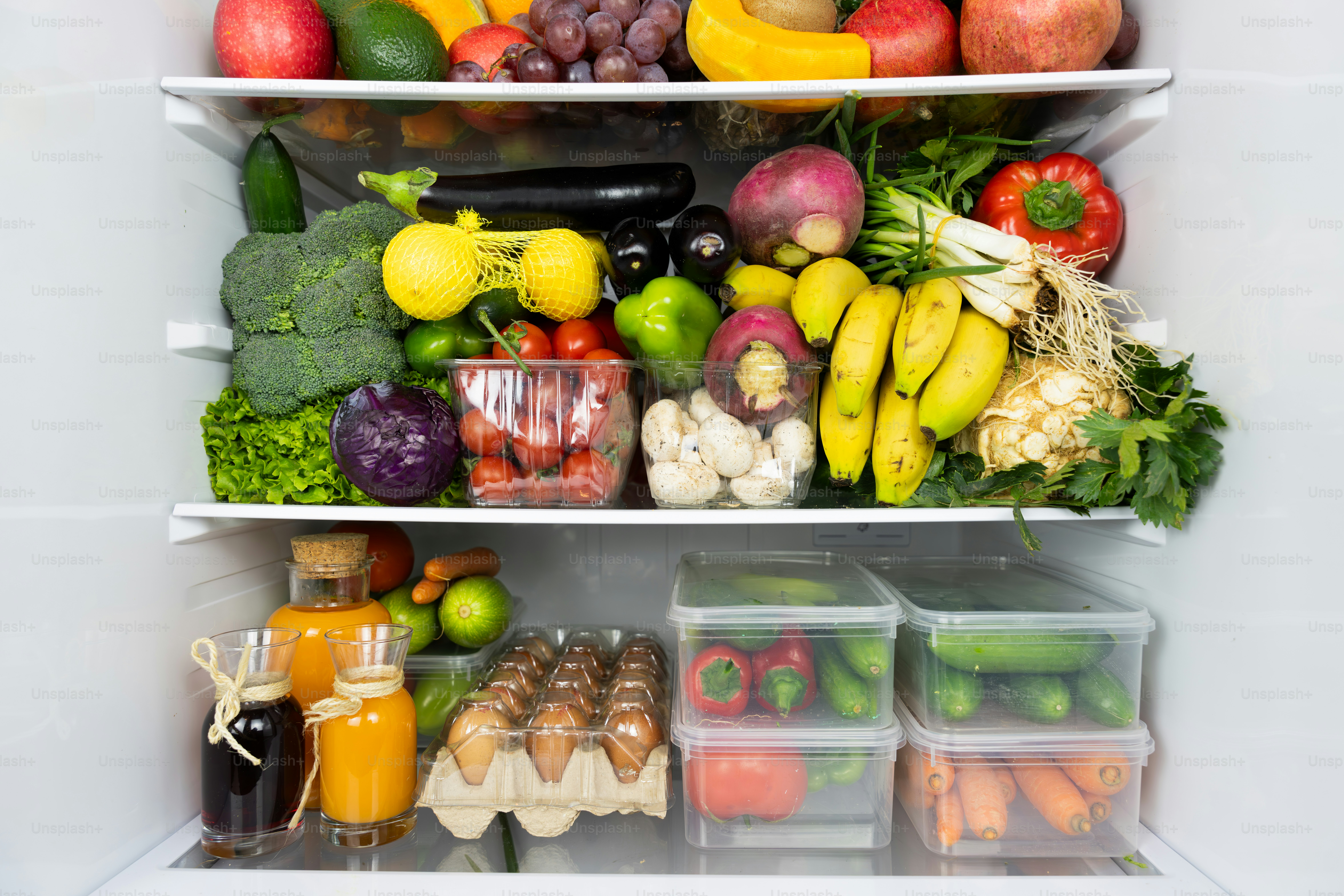A refrigerator filled with lots of different types of fruits and ...