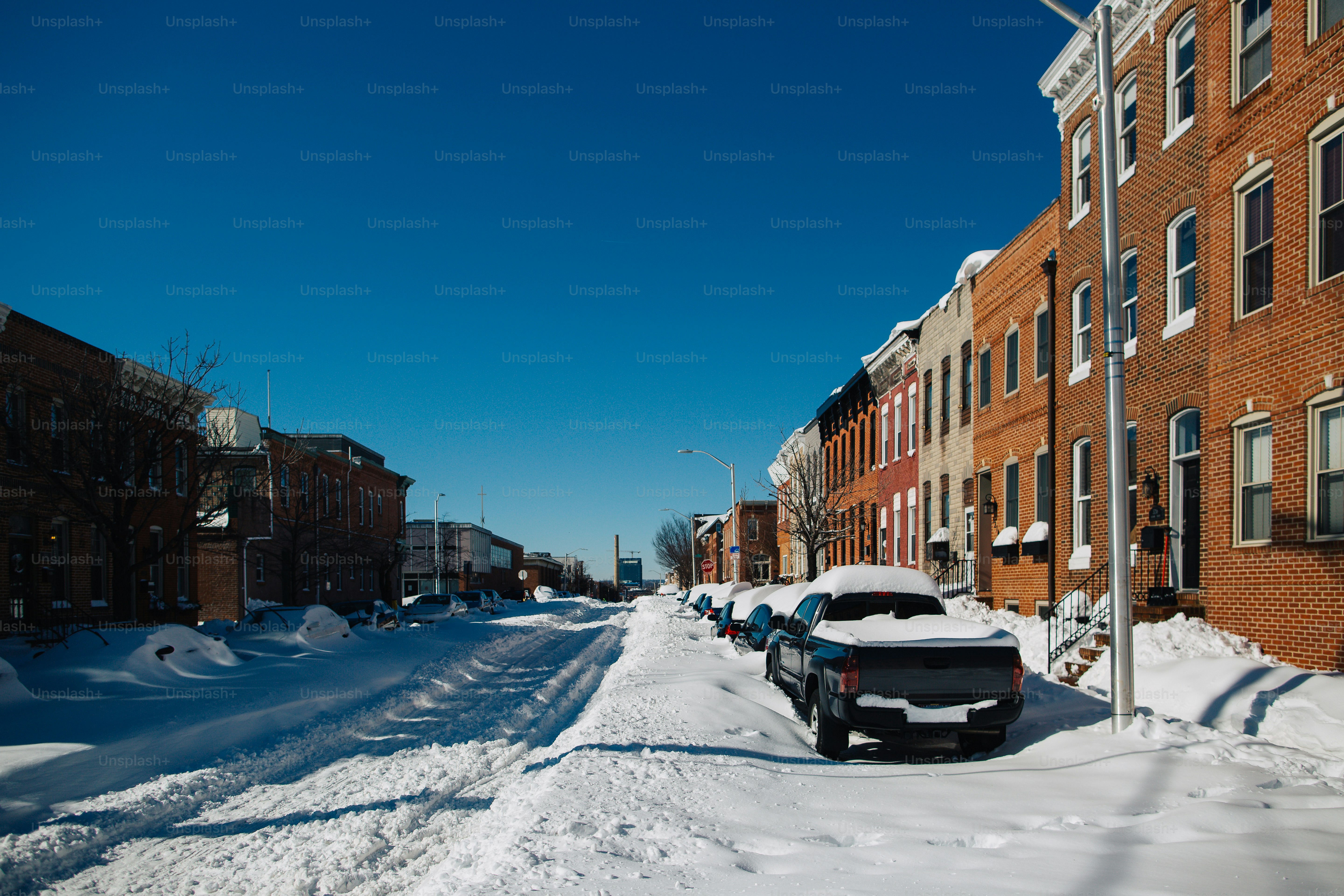A car is parked on a snowy street