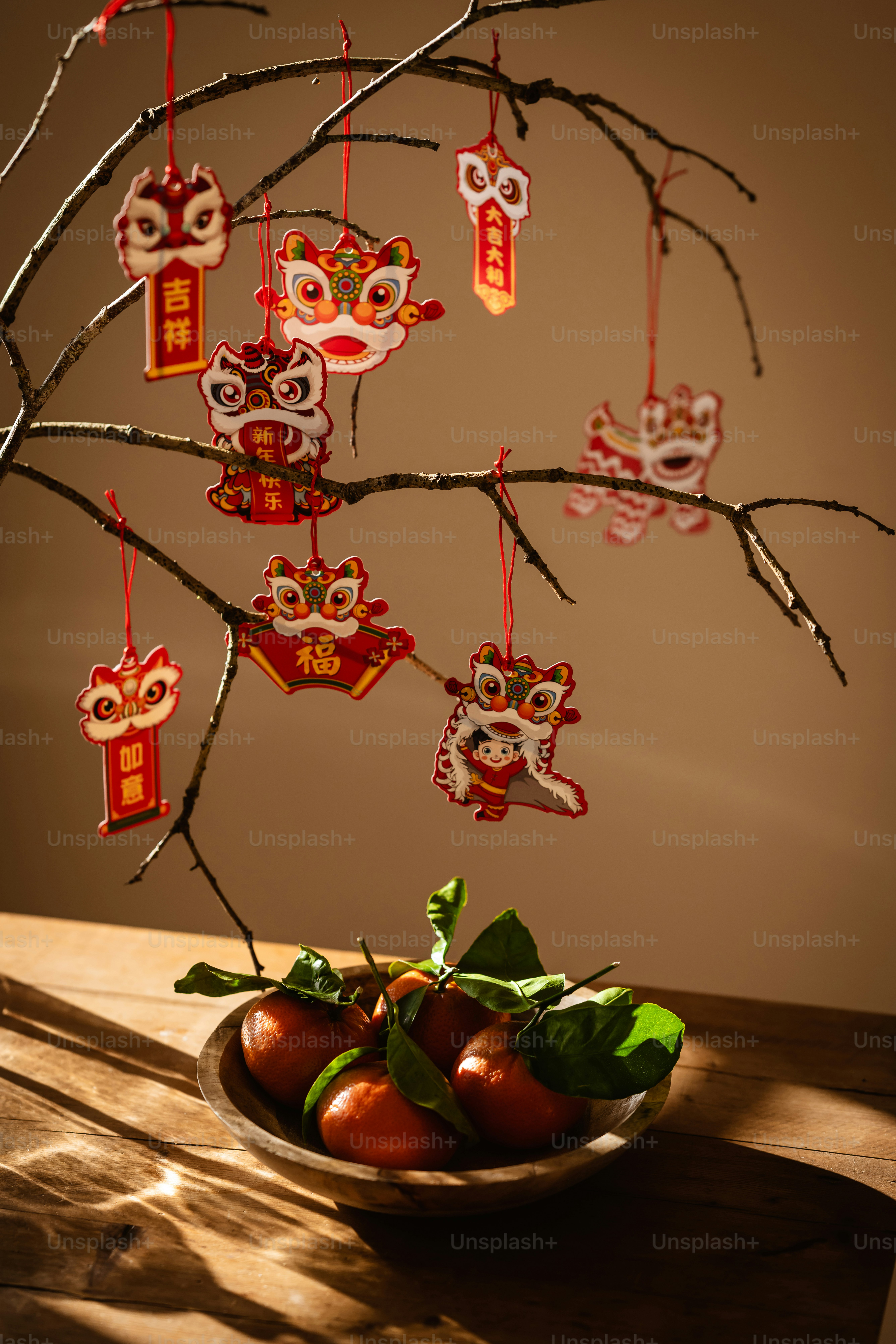 A bowl of fruit sitting on a table next to a tree
