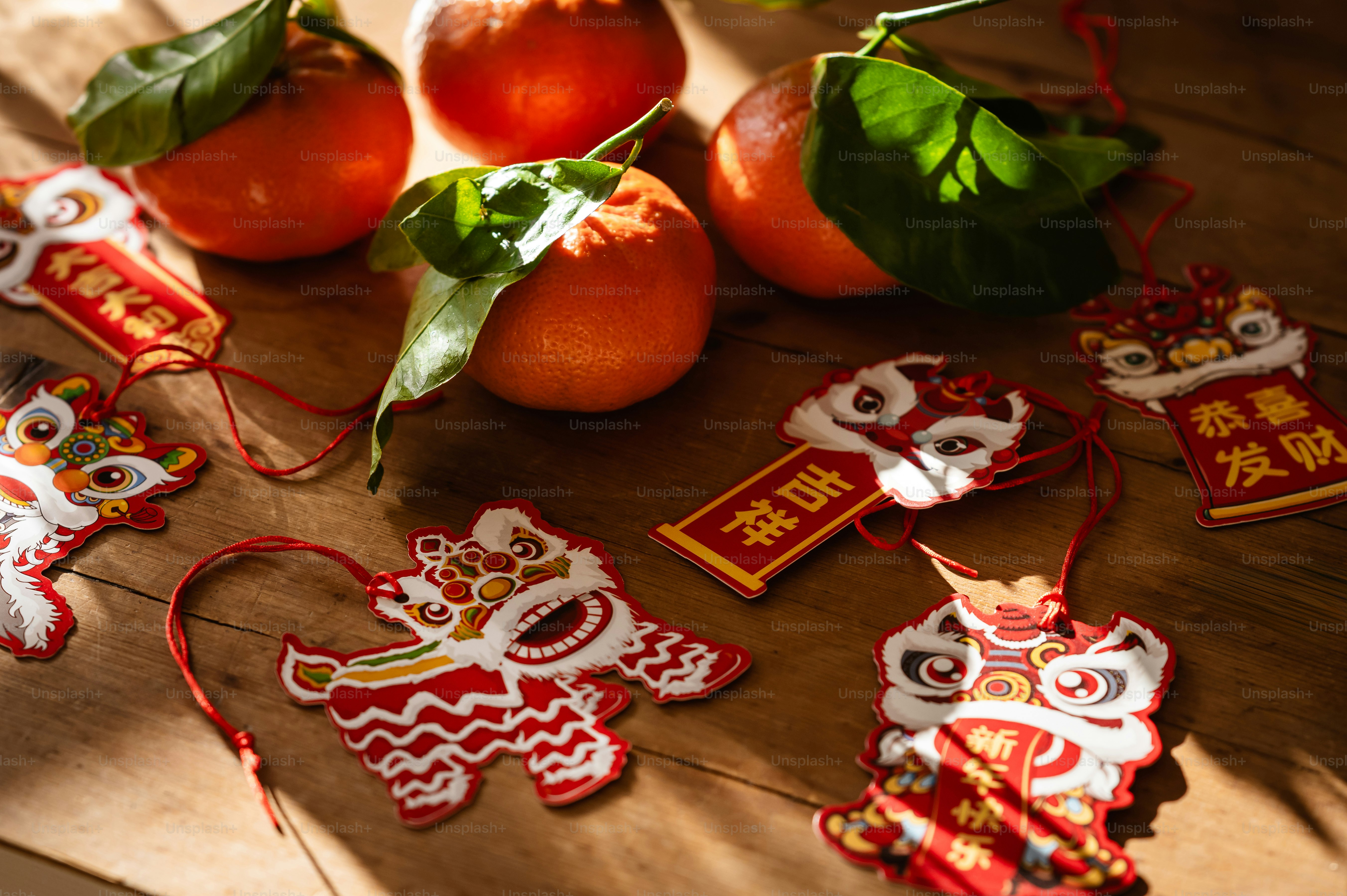 A table topped with oranges and decorations on top of a wooden table