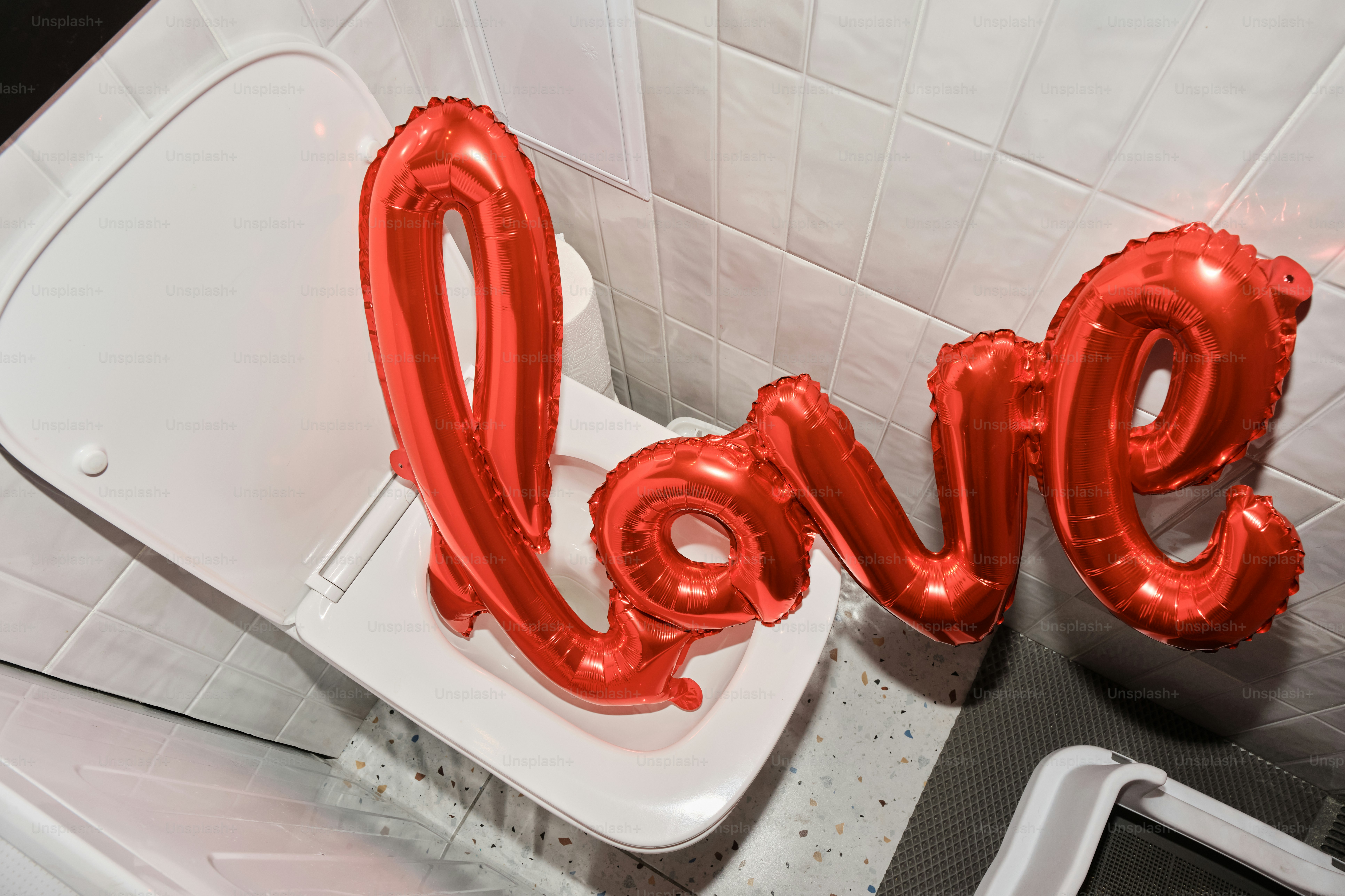 A toilet with the word love spelled out of it