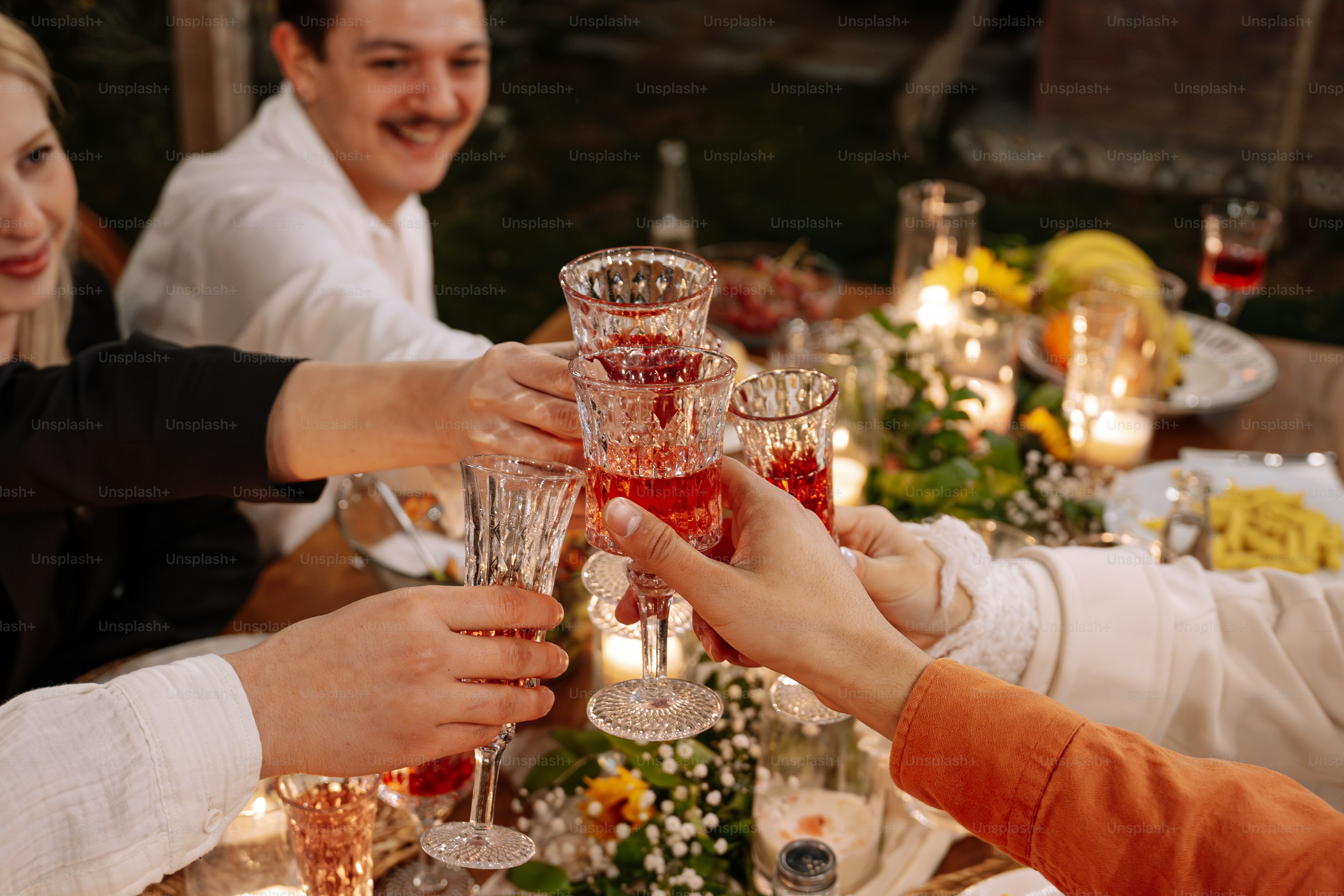 A group of people sitting around a table with wine glasses