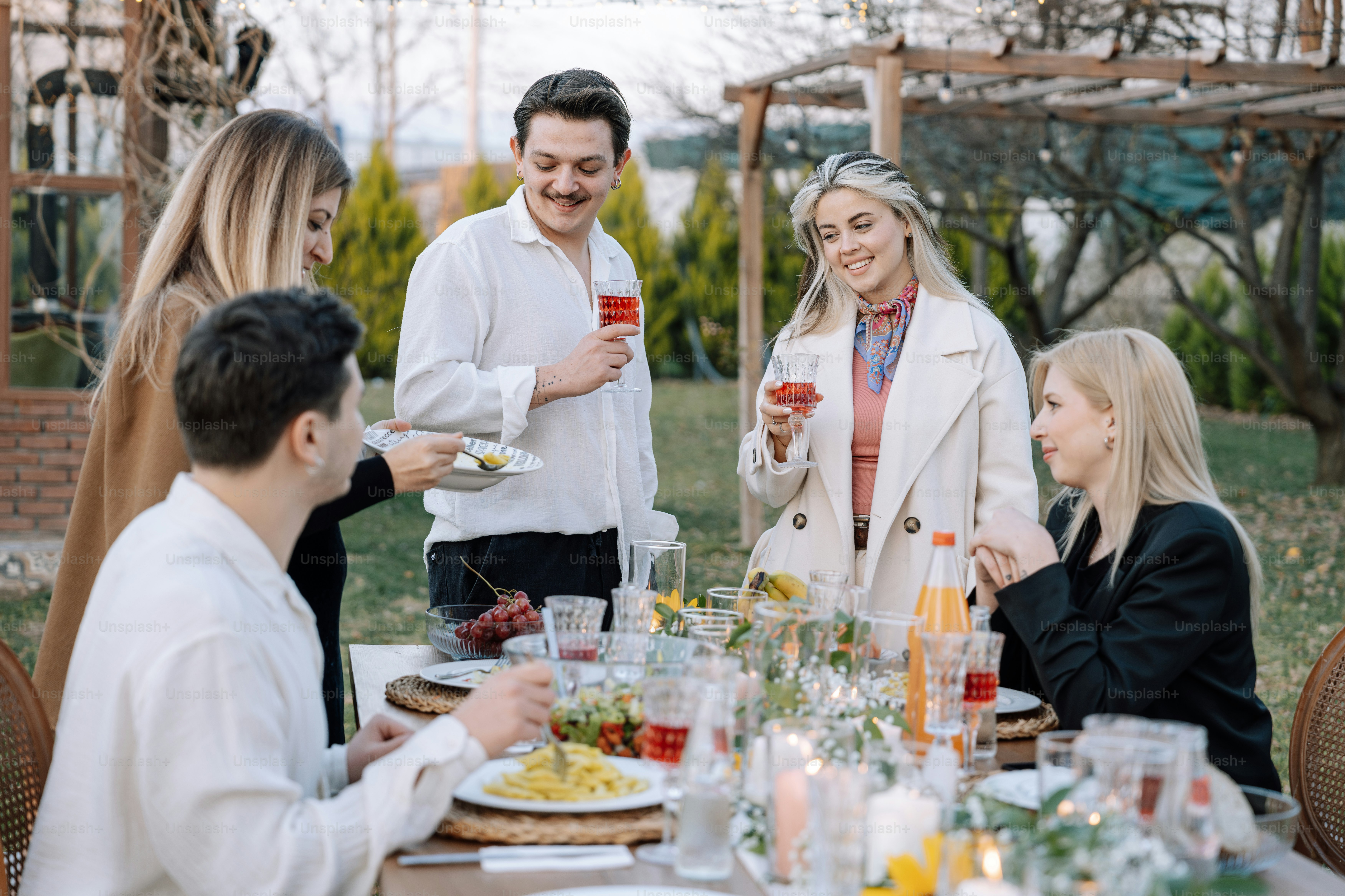 A group of people sitting around a table eating food