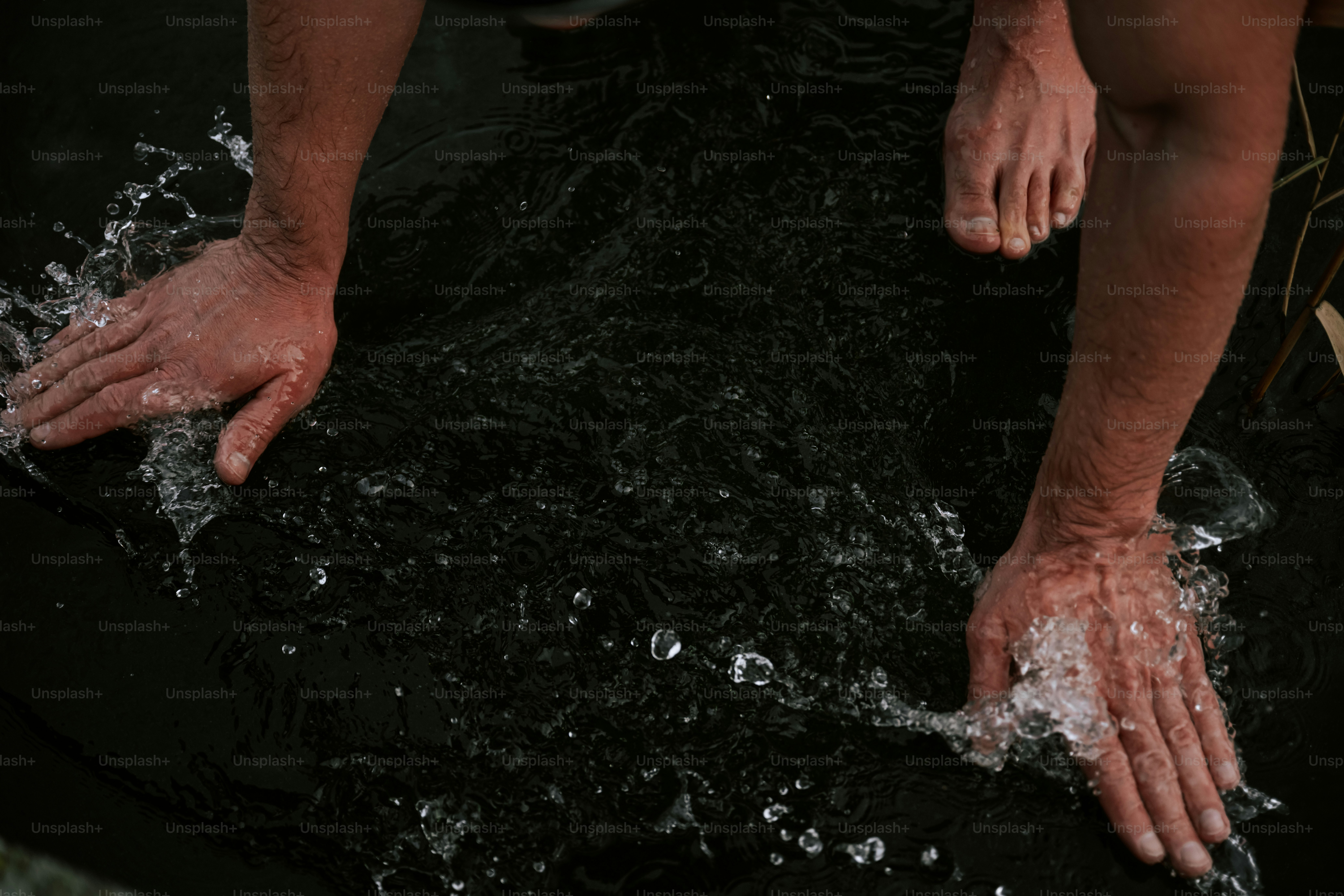 A man is washing his hands in the water