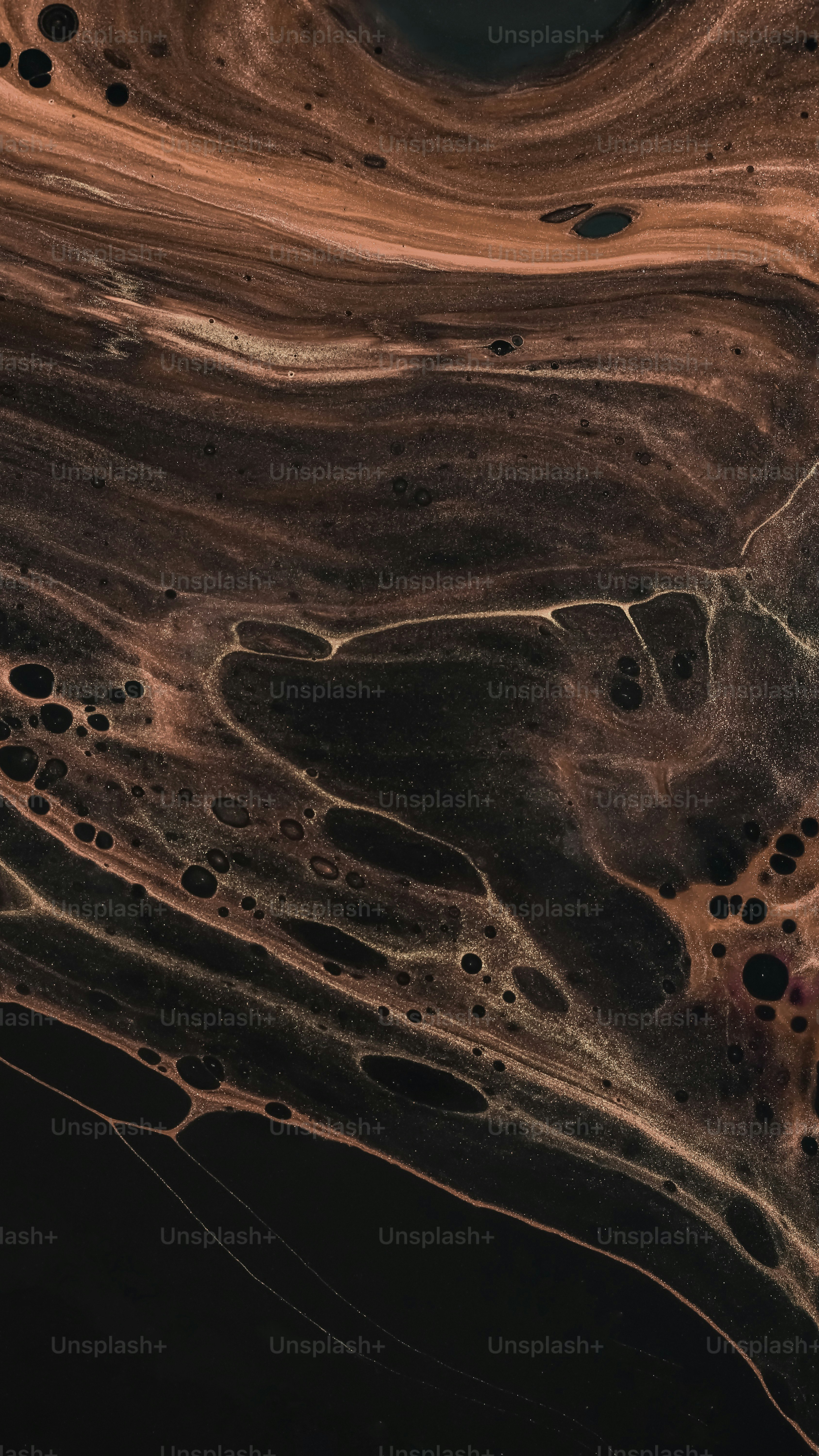 An aerial view of a brown and black landscape