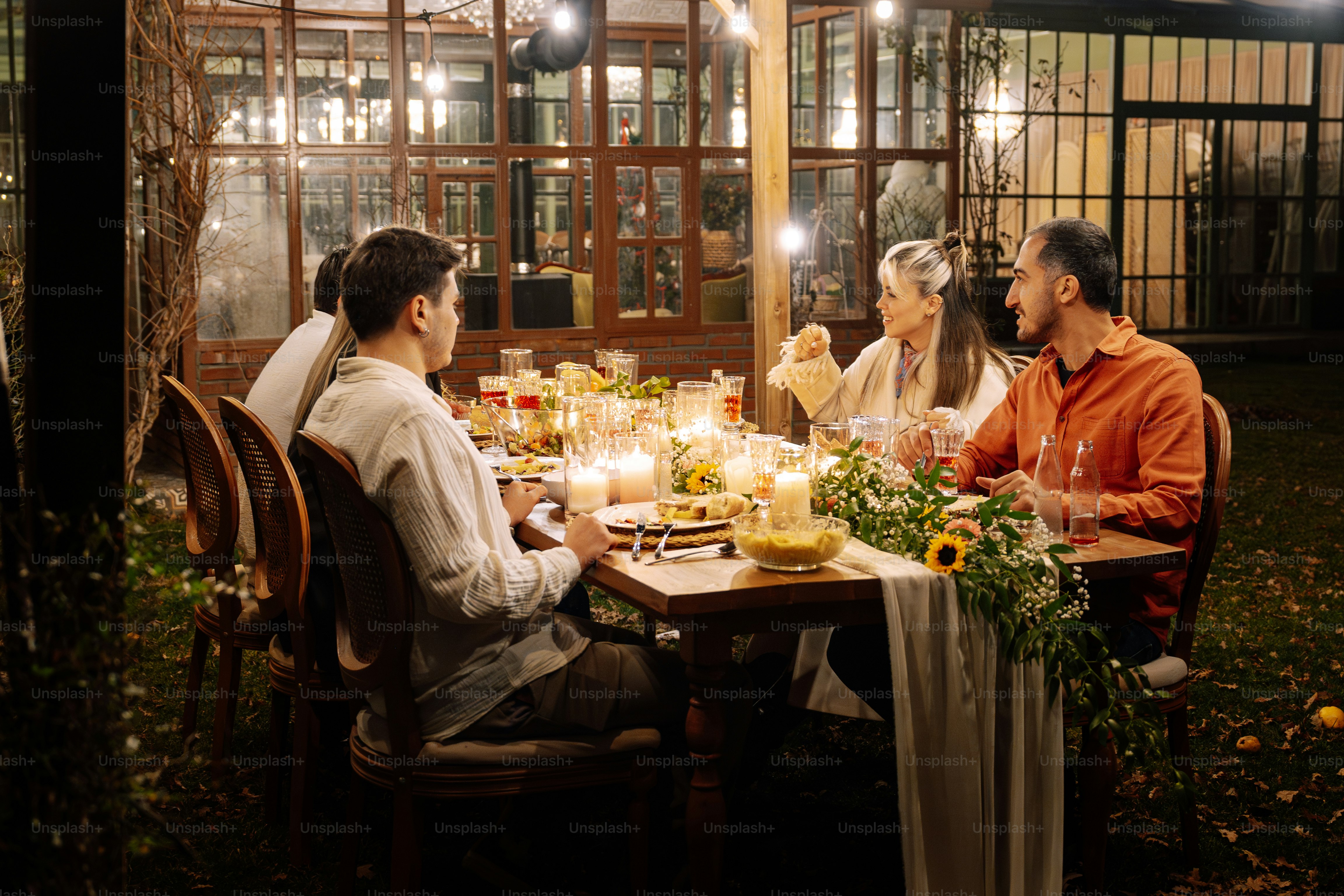 A group of people sitting around a dinner table