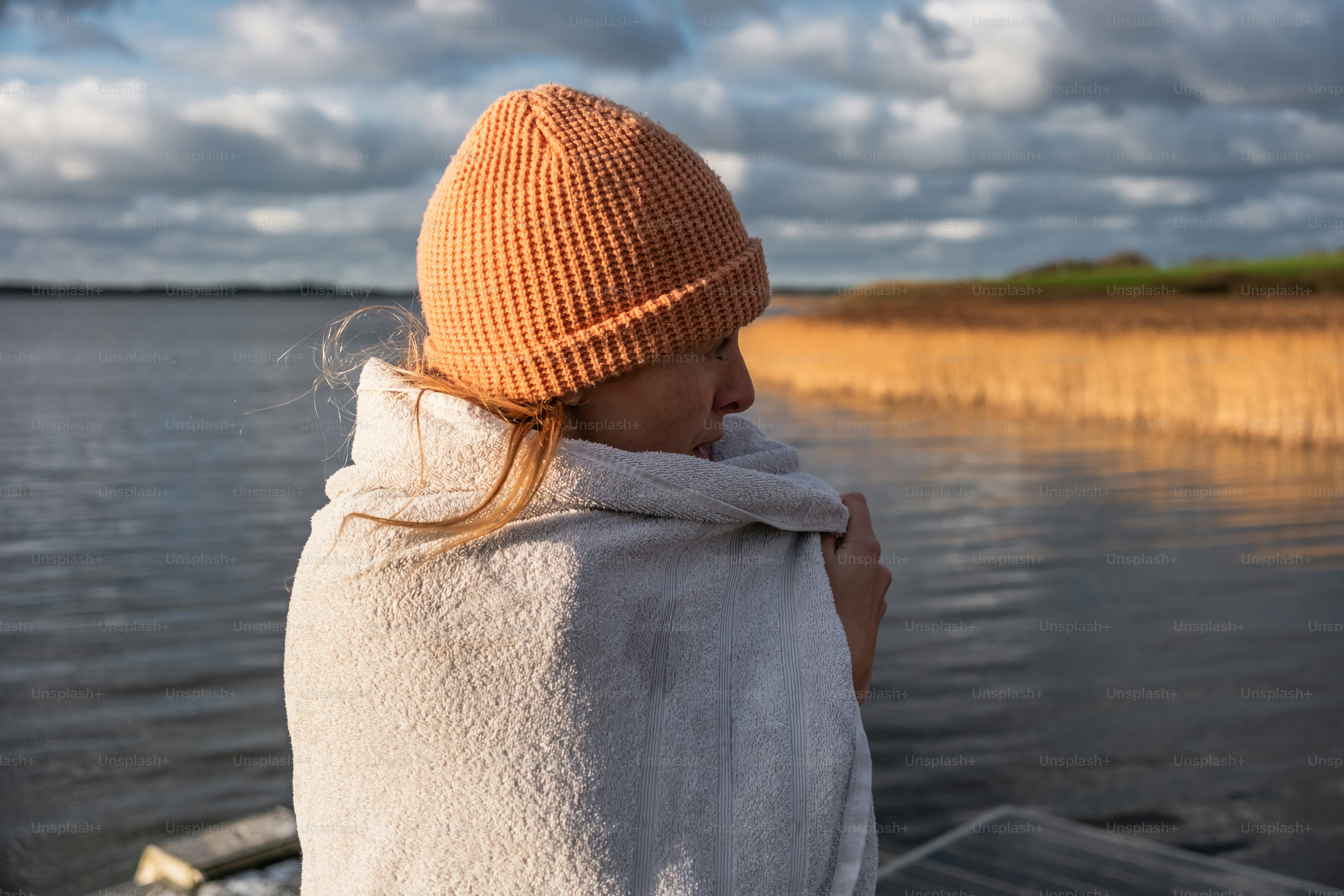 A woman sitting on a boat looking out at the water
