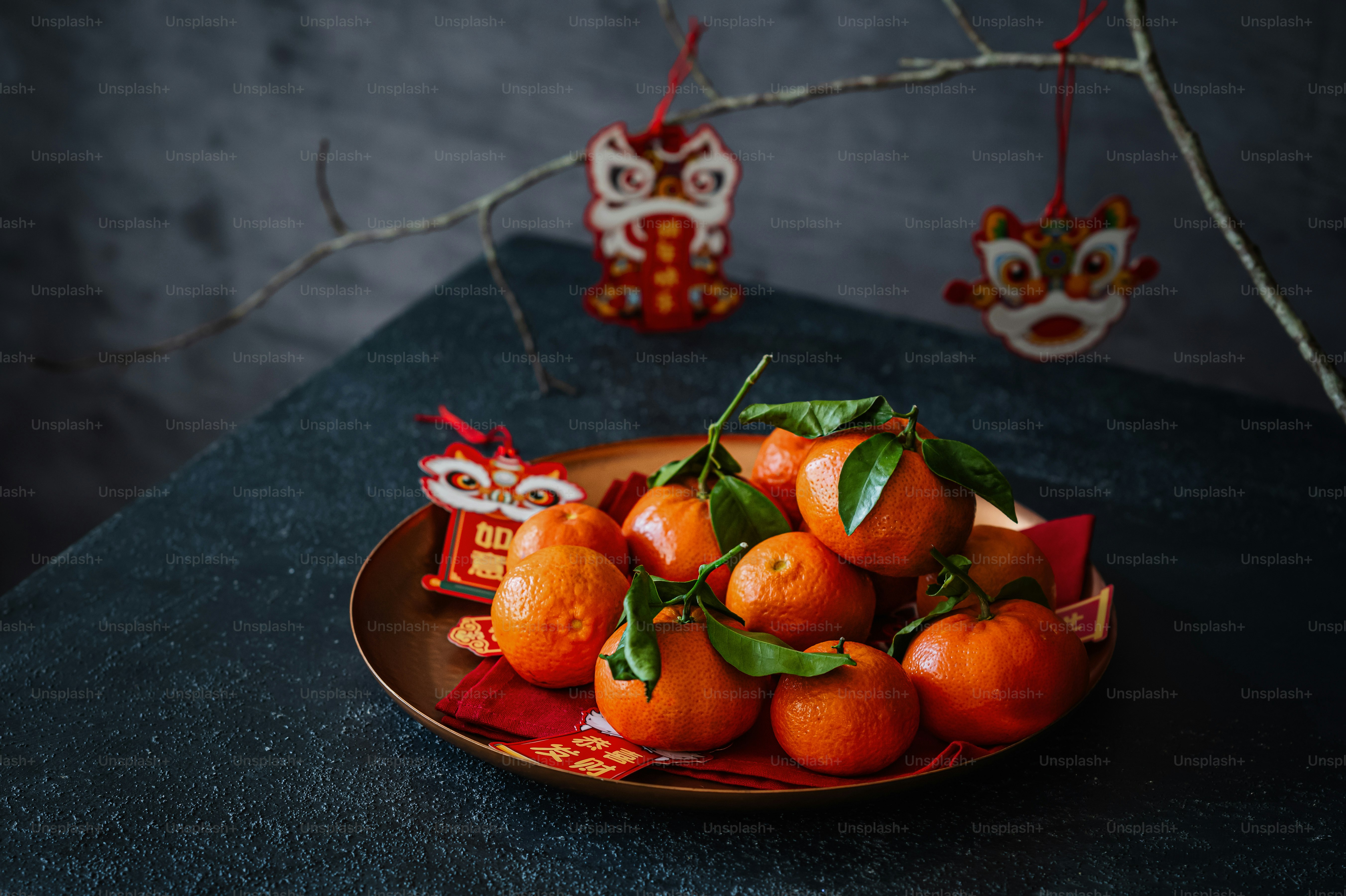 A plate of tangerines on a table