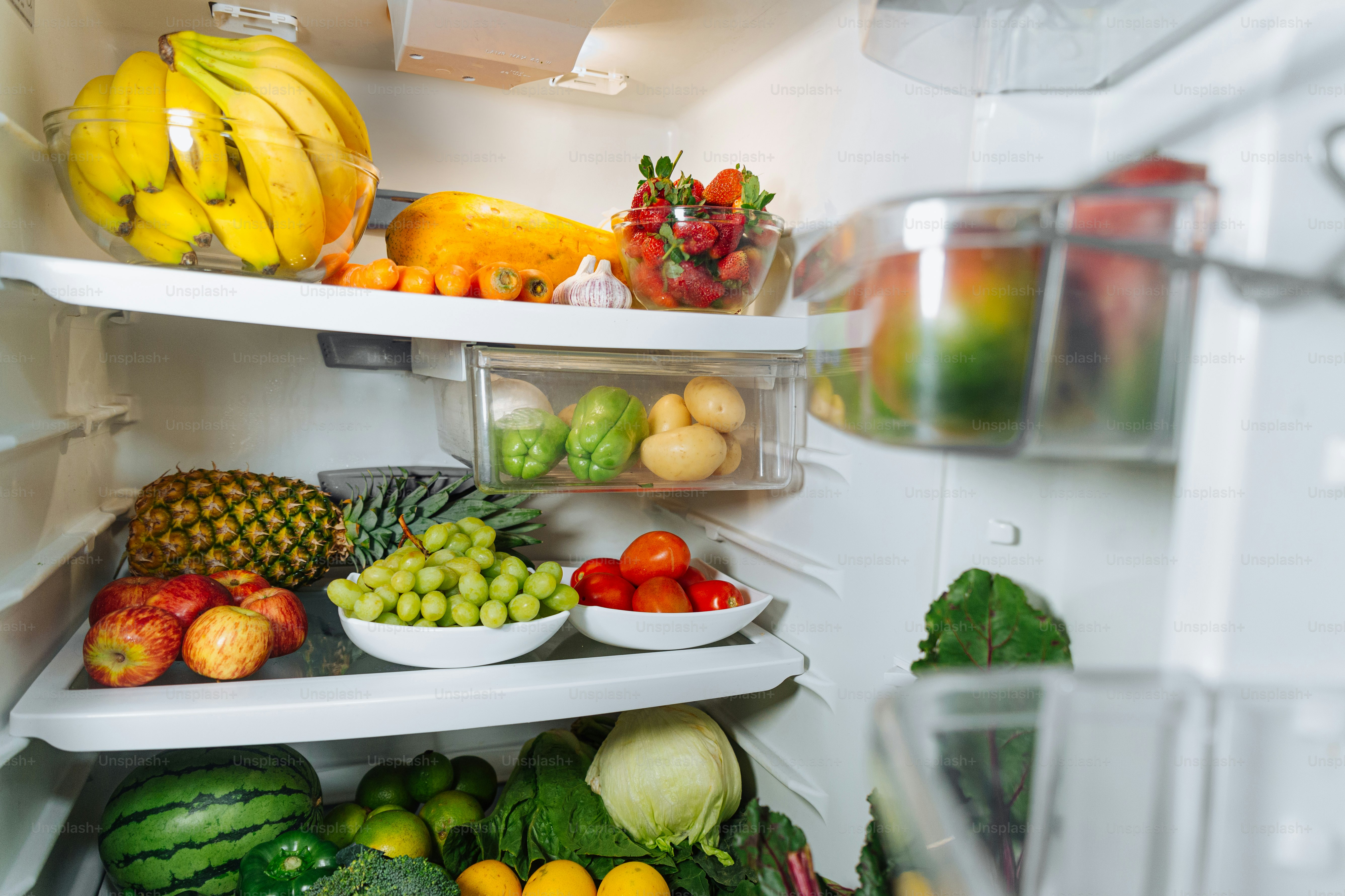 A refrigerator filled with lots of fresh fruits and vegetables