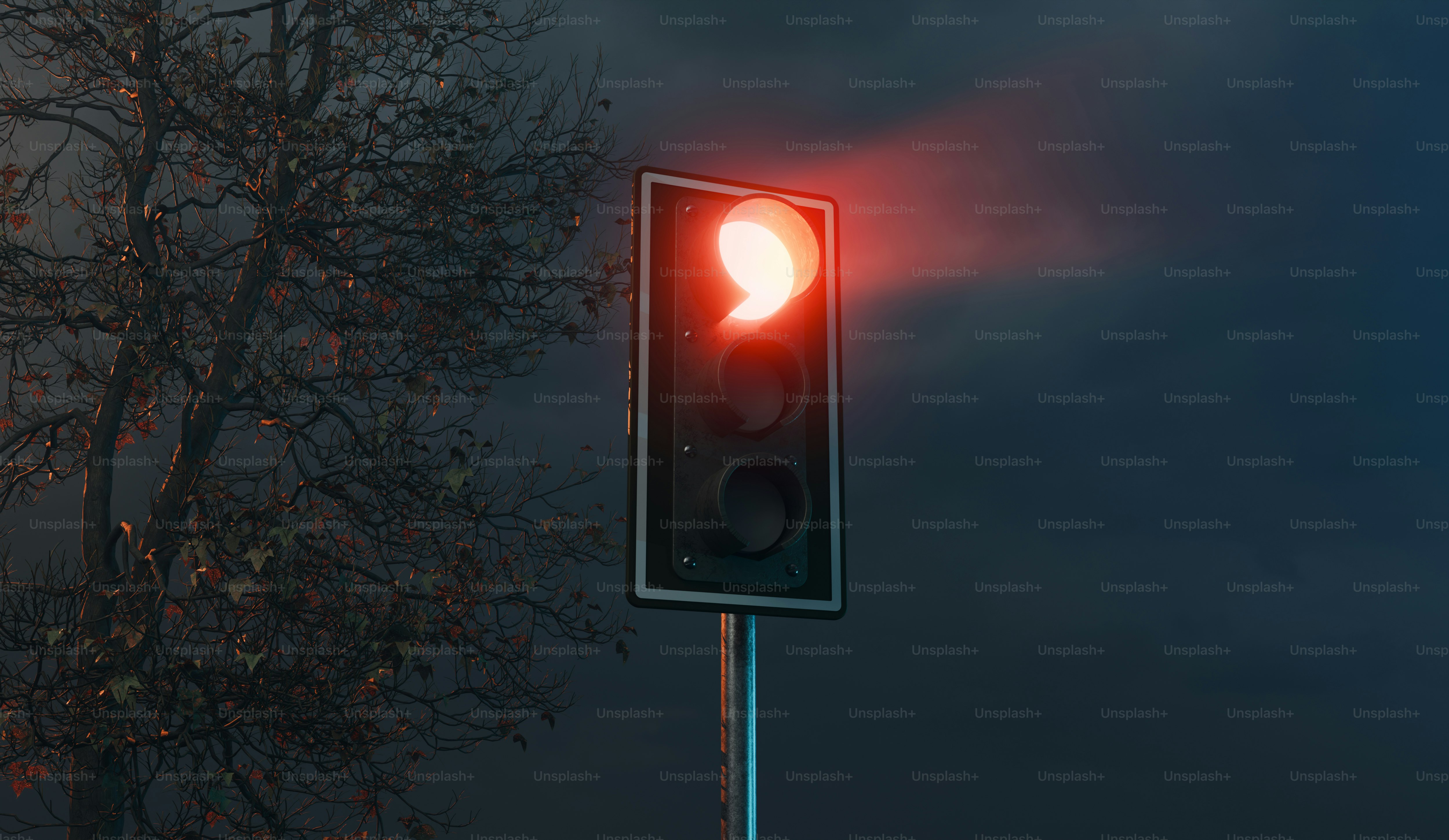 A traffic light on a pole with a tree in the background