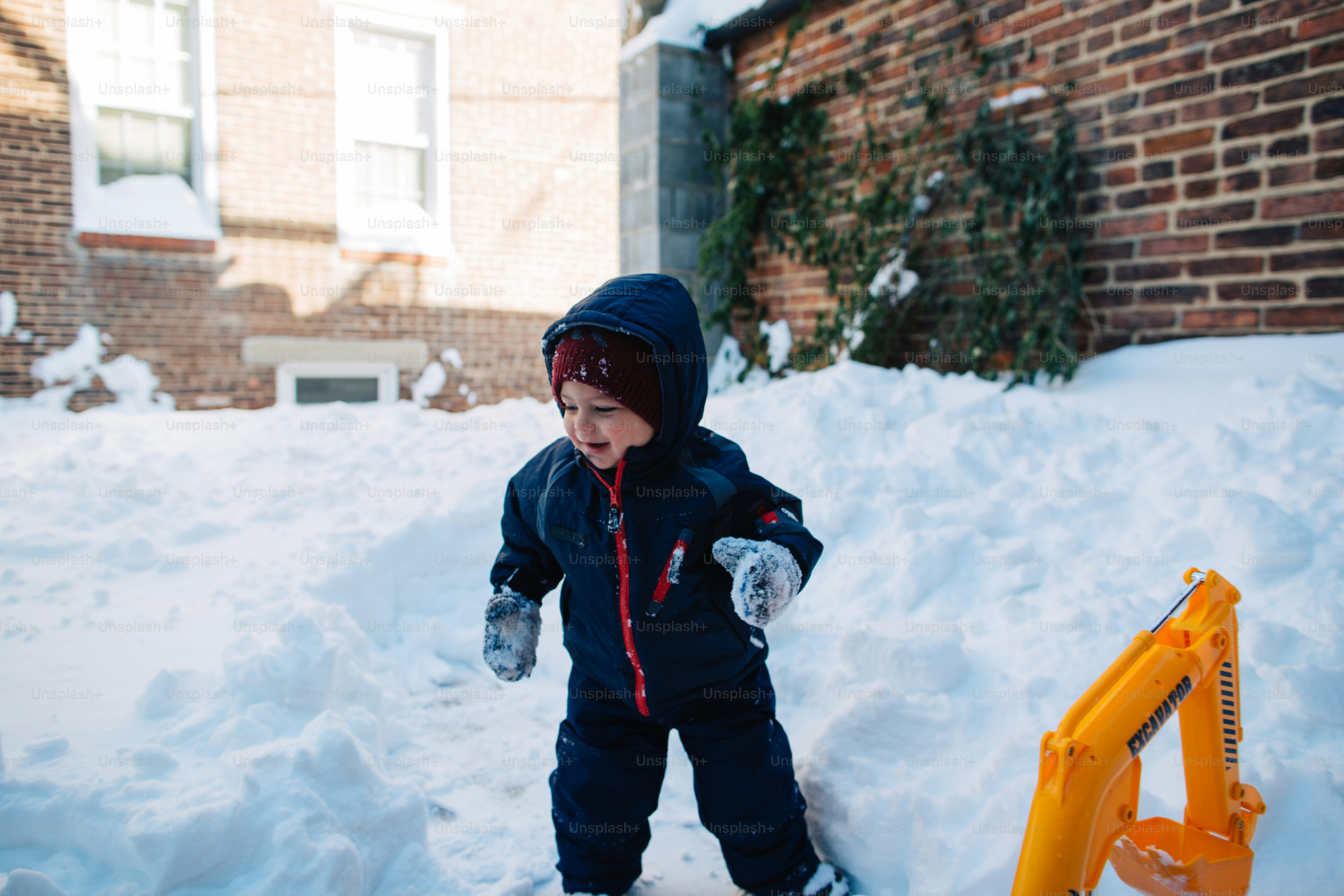 A small child is playing in the snow