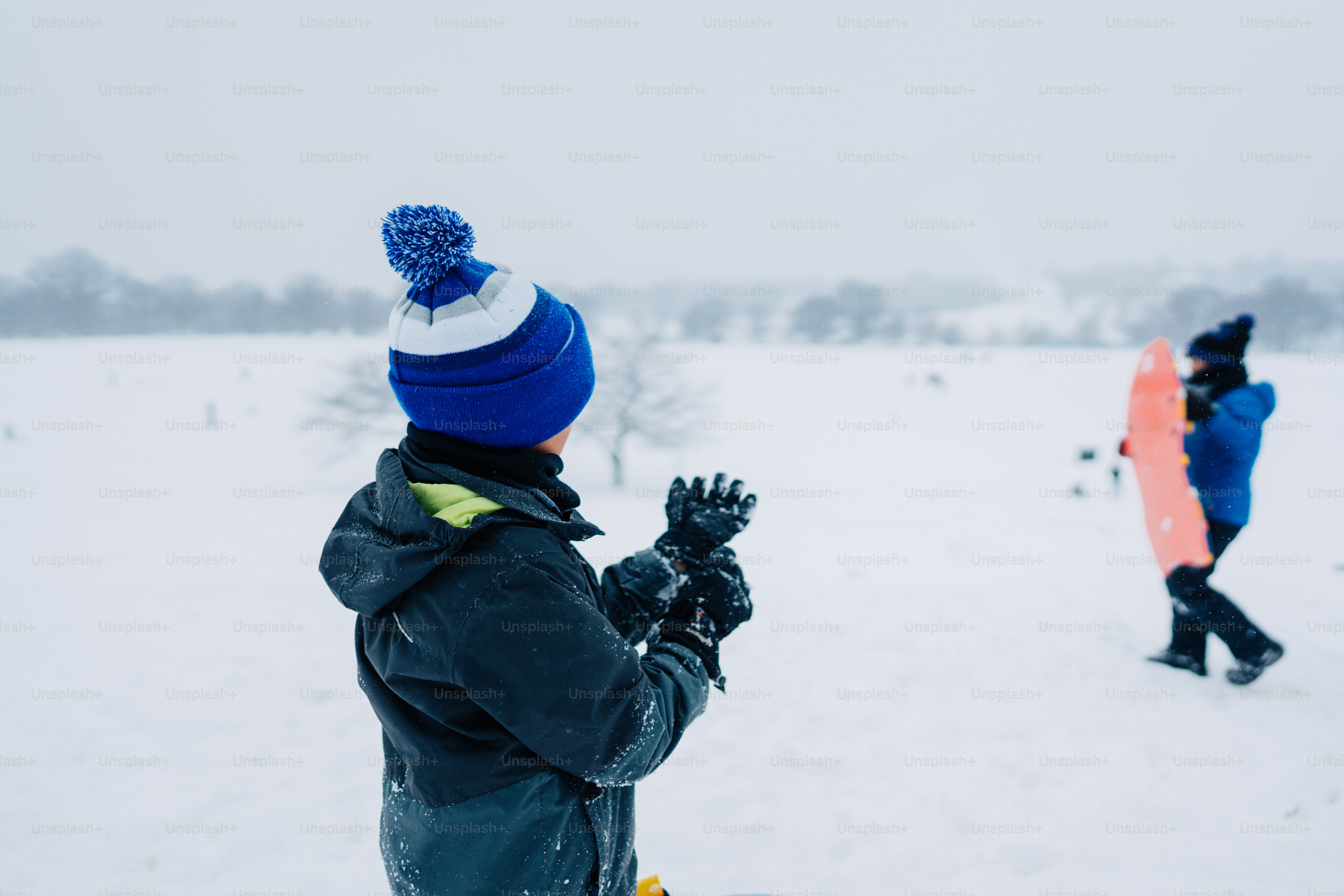 A couple of people that are standing in the snow