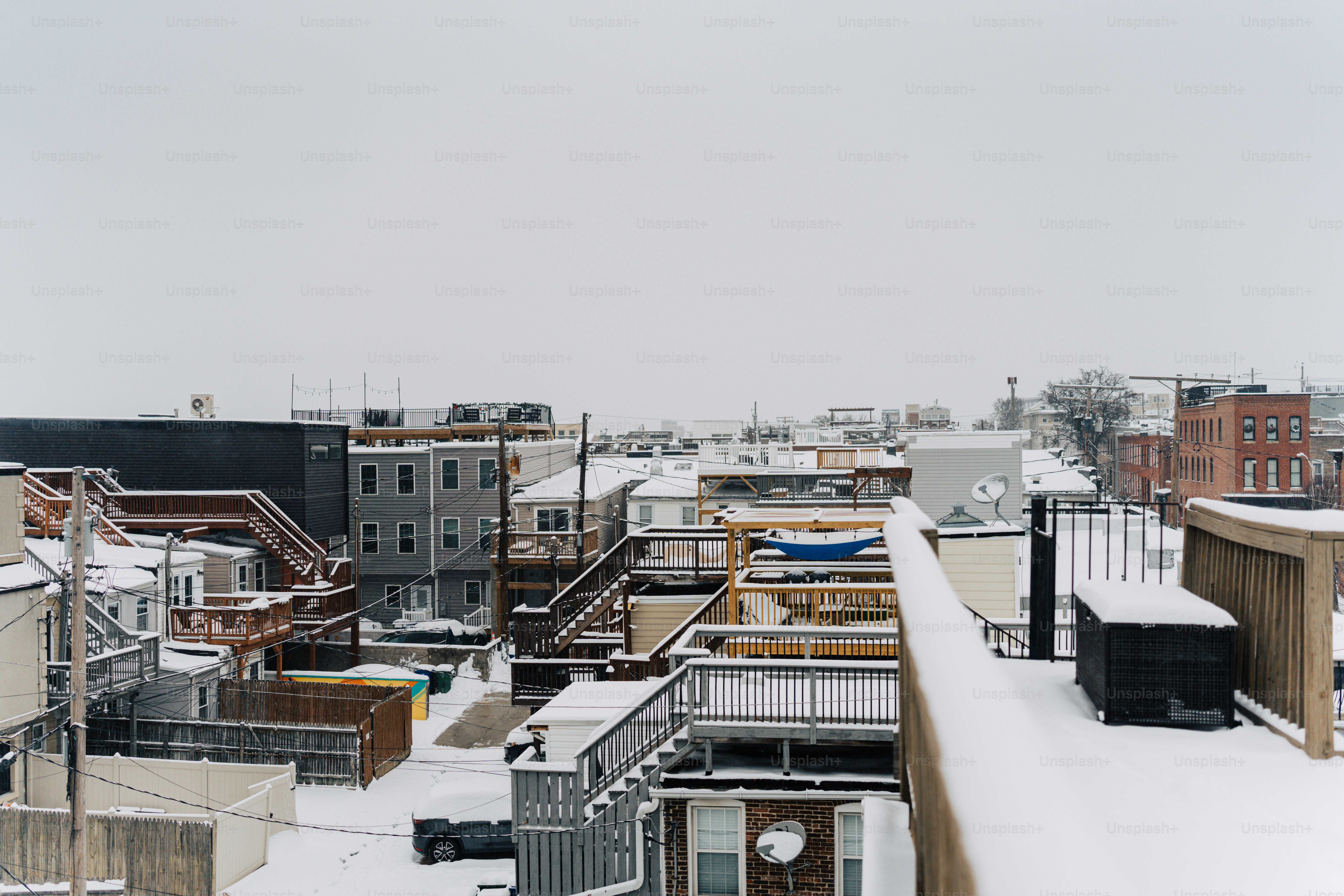 A snow covered rooftop with buildings in the background