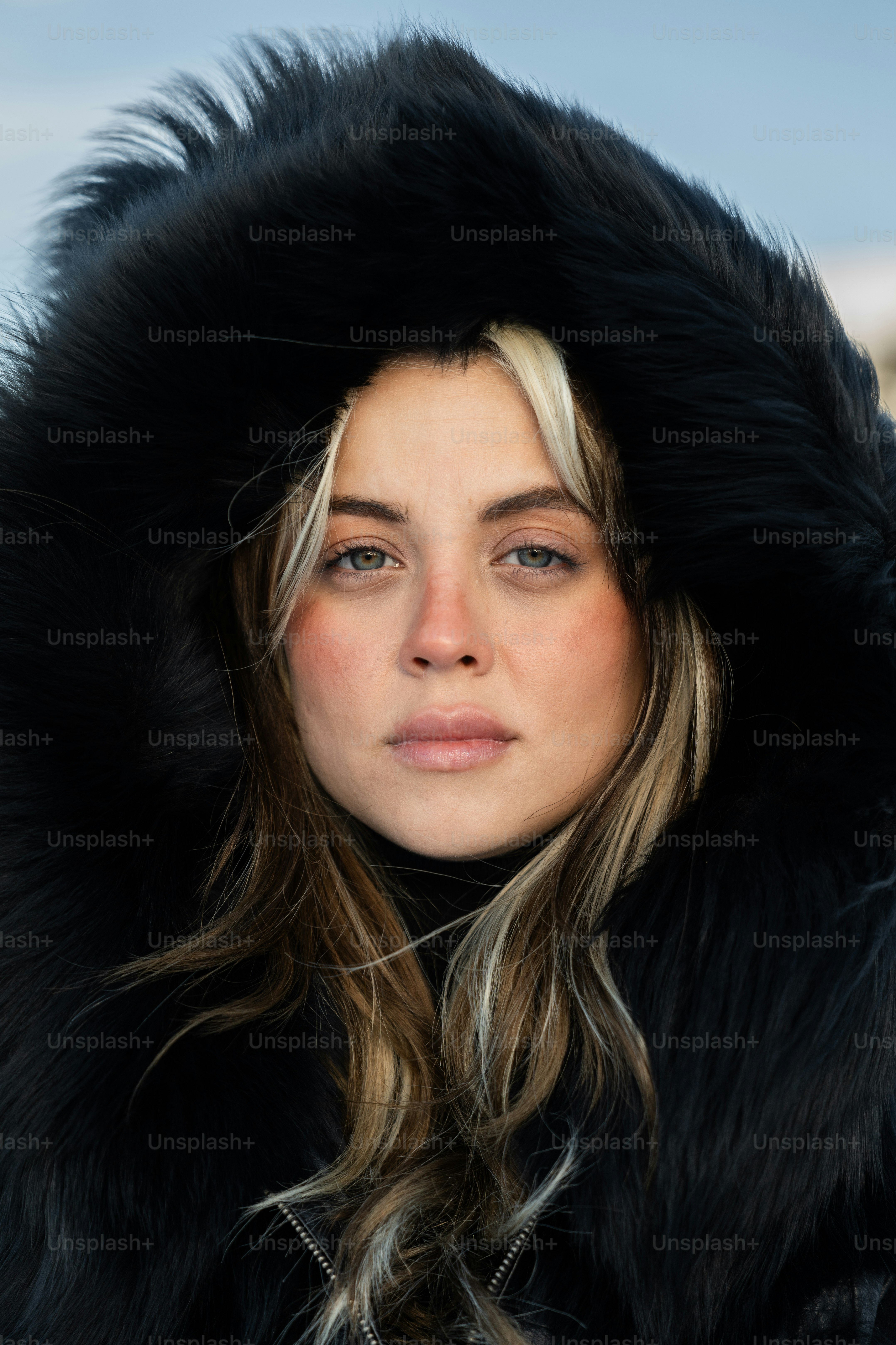 A woman wearing a black fur coat