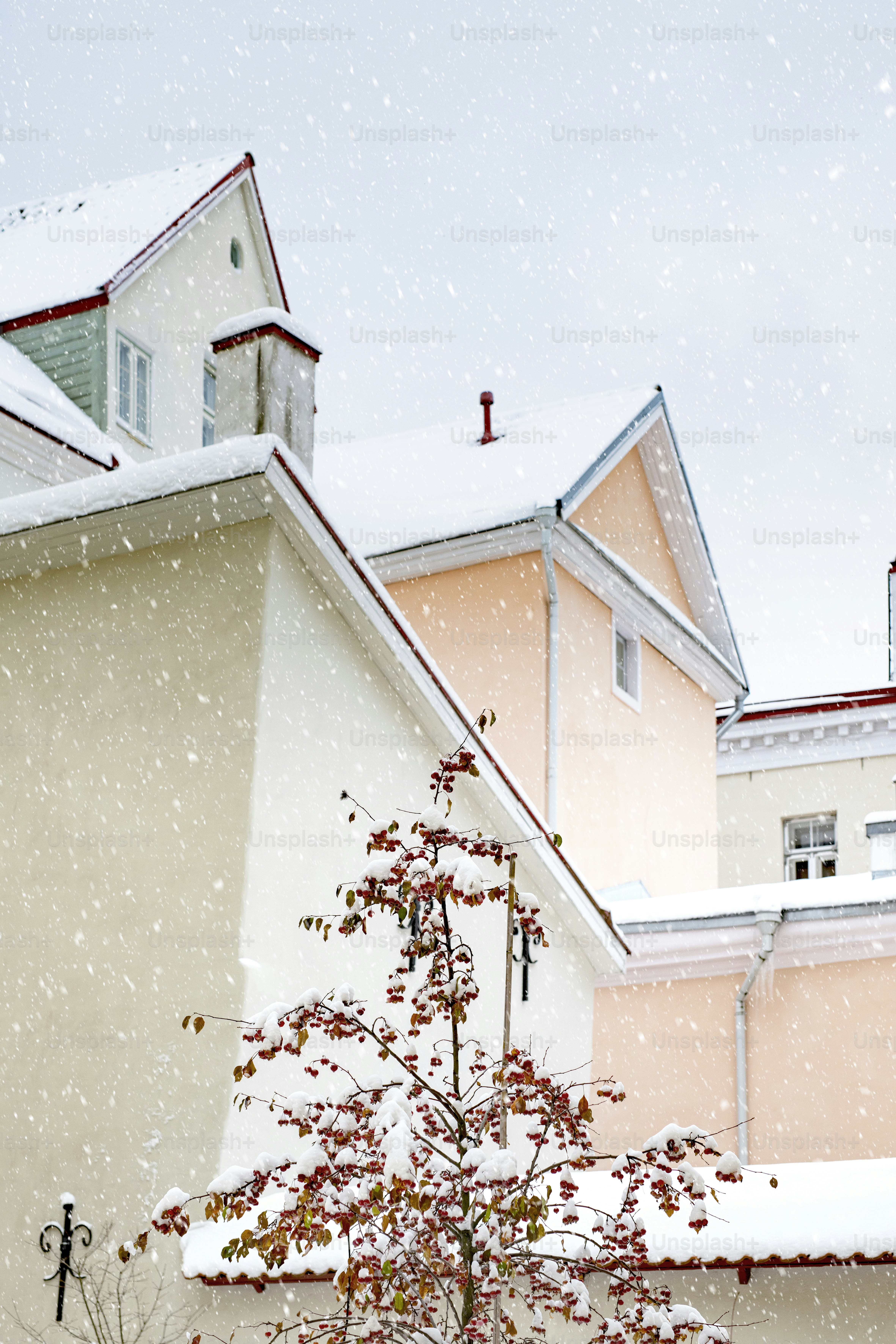 A snow covered building with a clock tower in the background