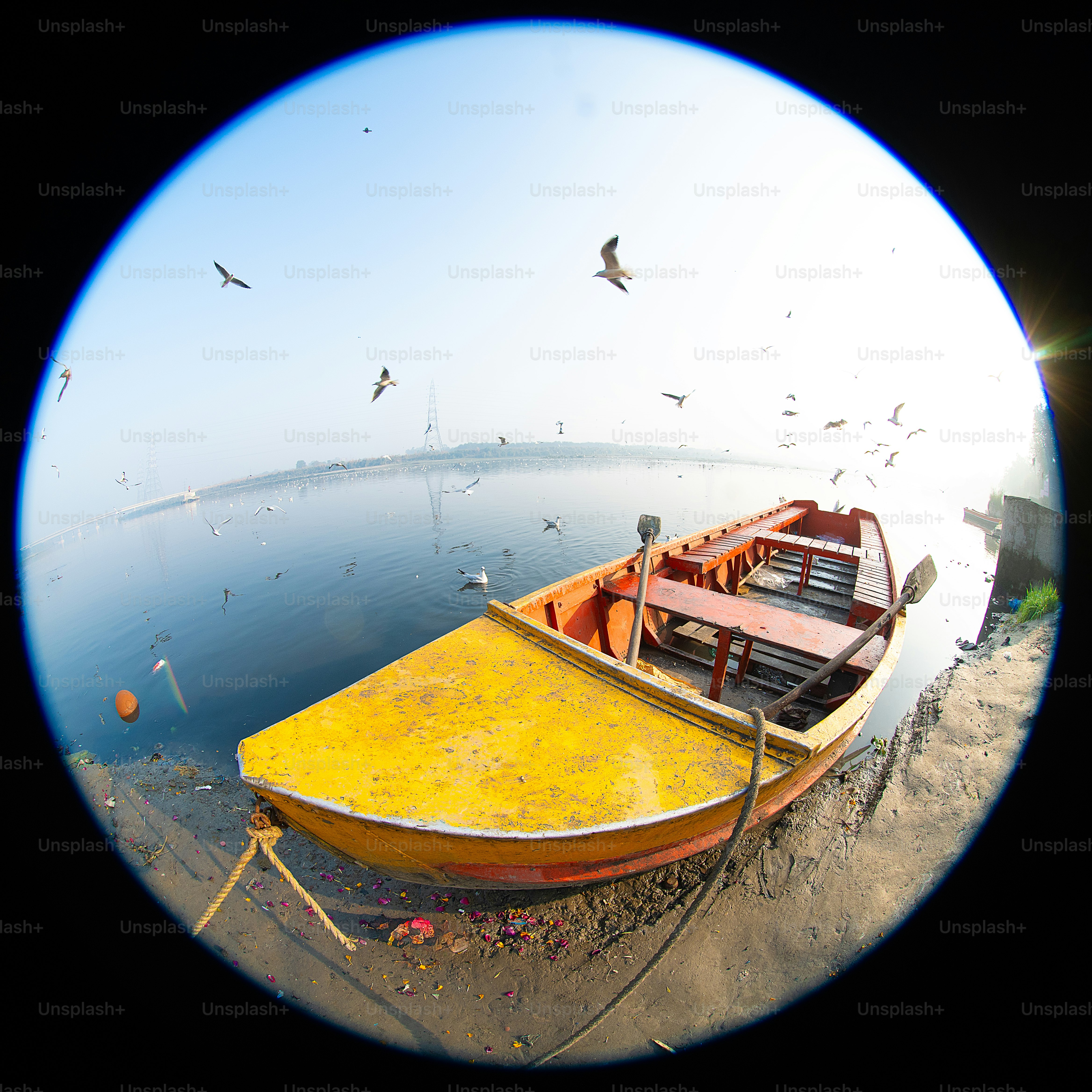 A yellow boat sitting on top of a body of water
