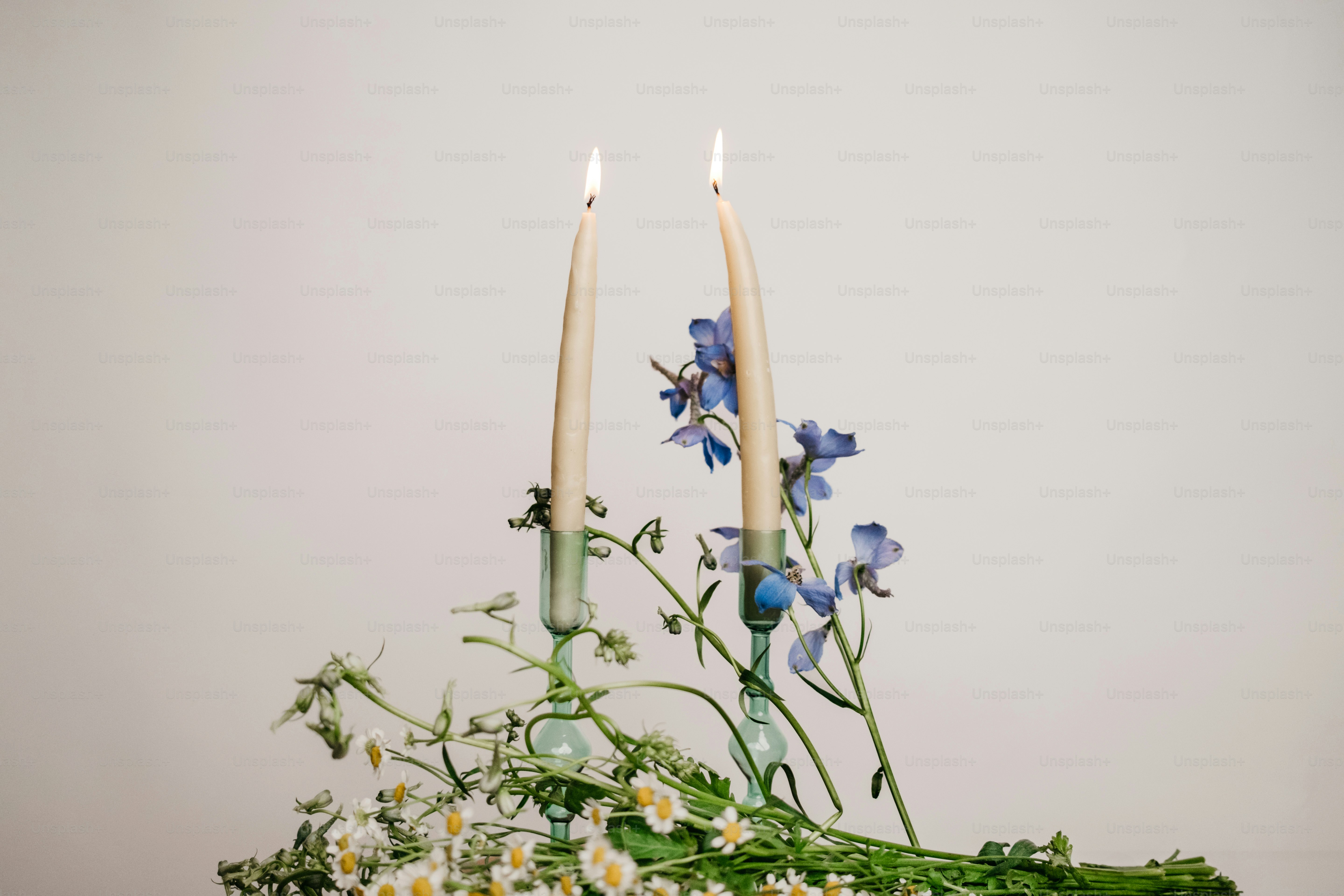 A basket filled with flowers and candles on top of a table