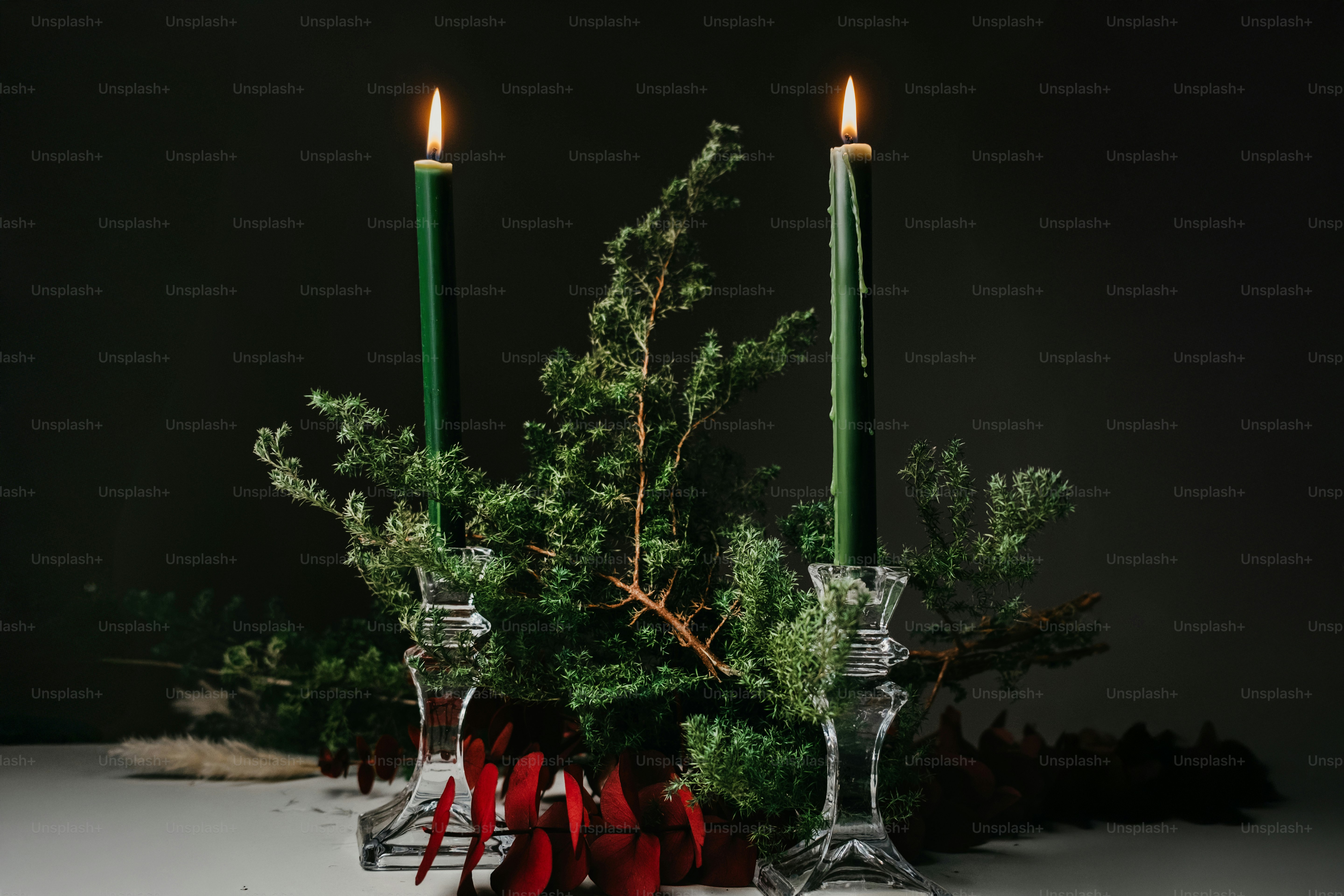 A table topped with candles and christmas decorations