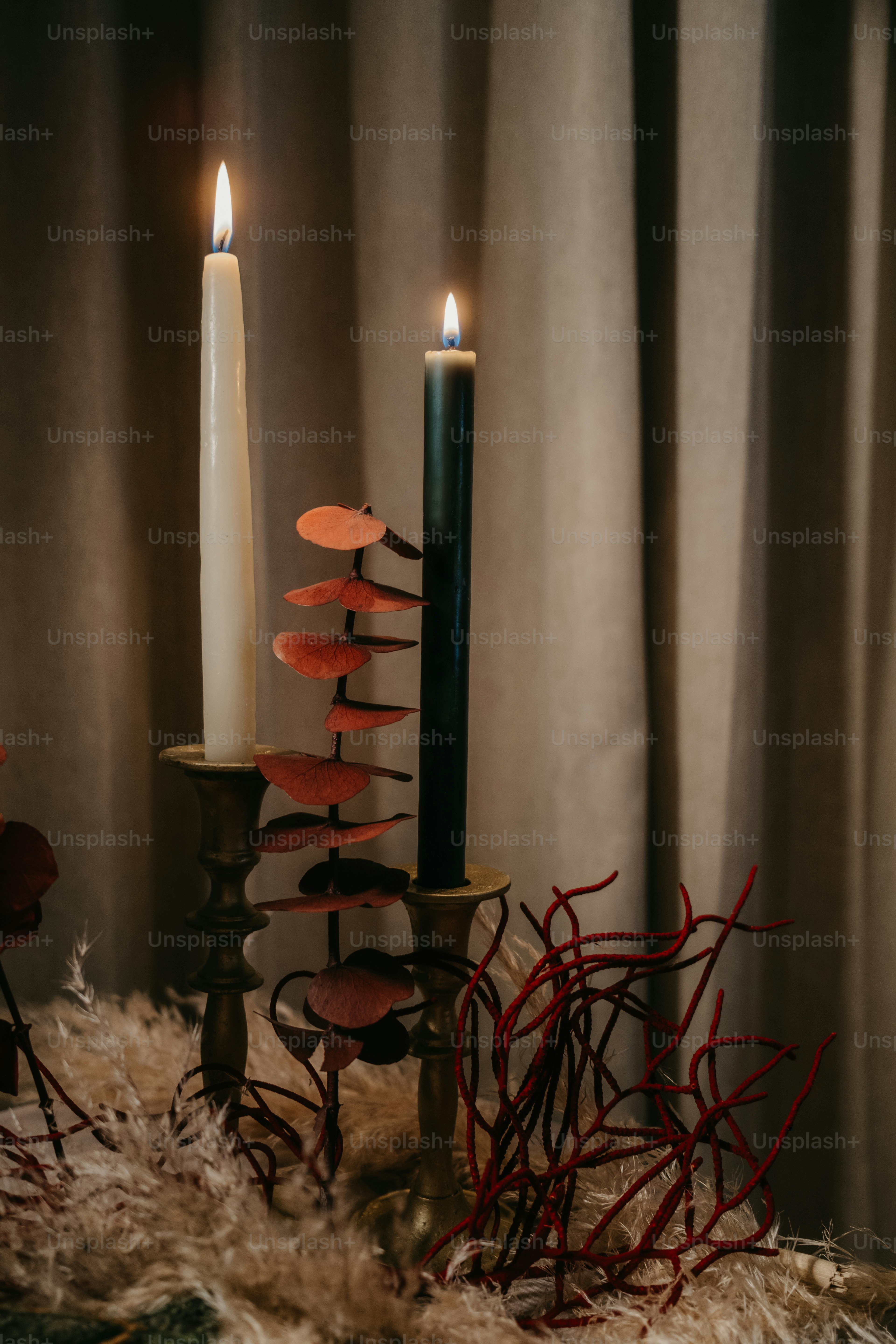 A couple of candles sitting on top of a table