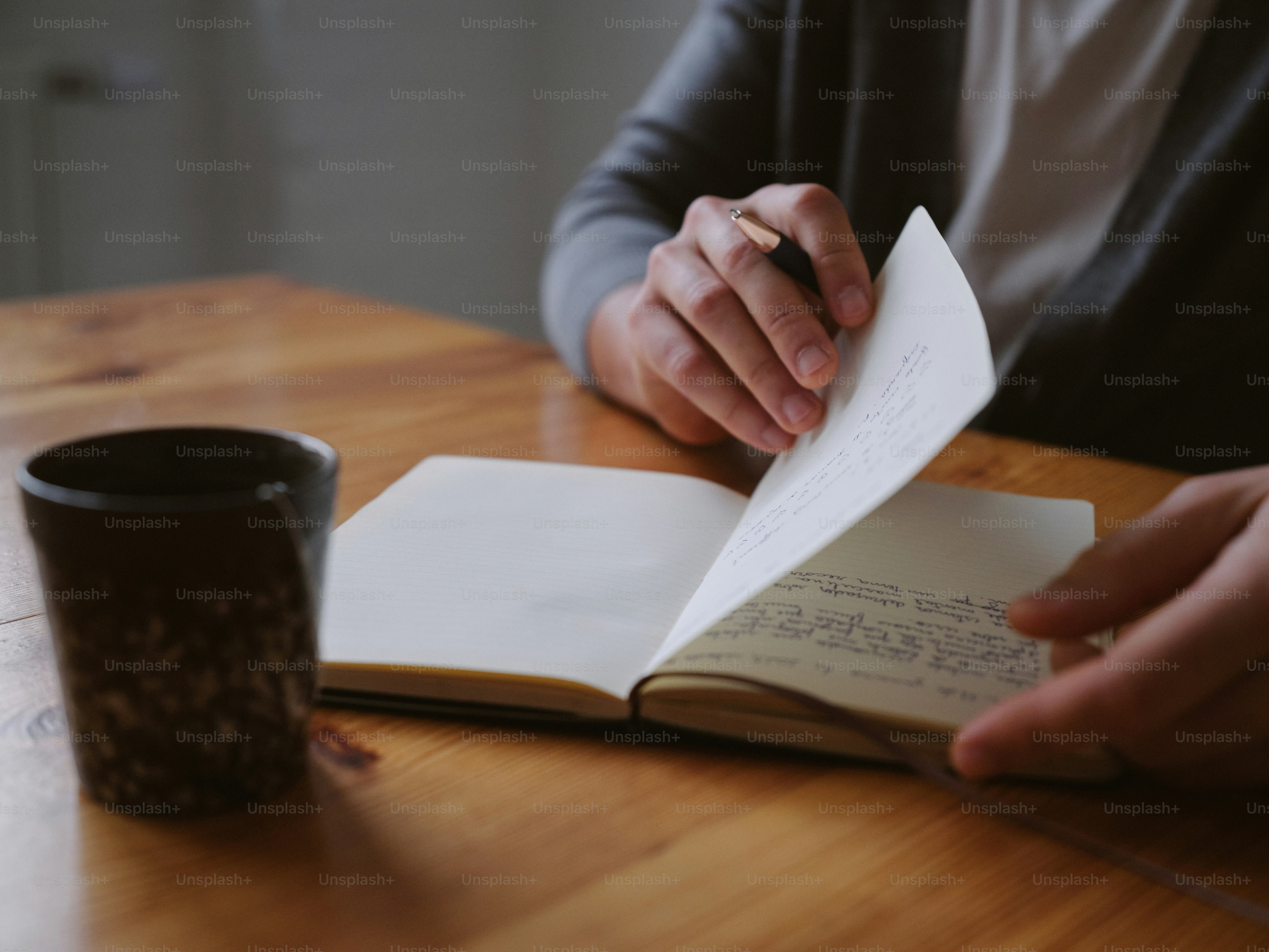 A person sitting at a table reading a book