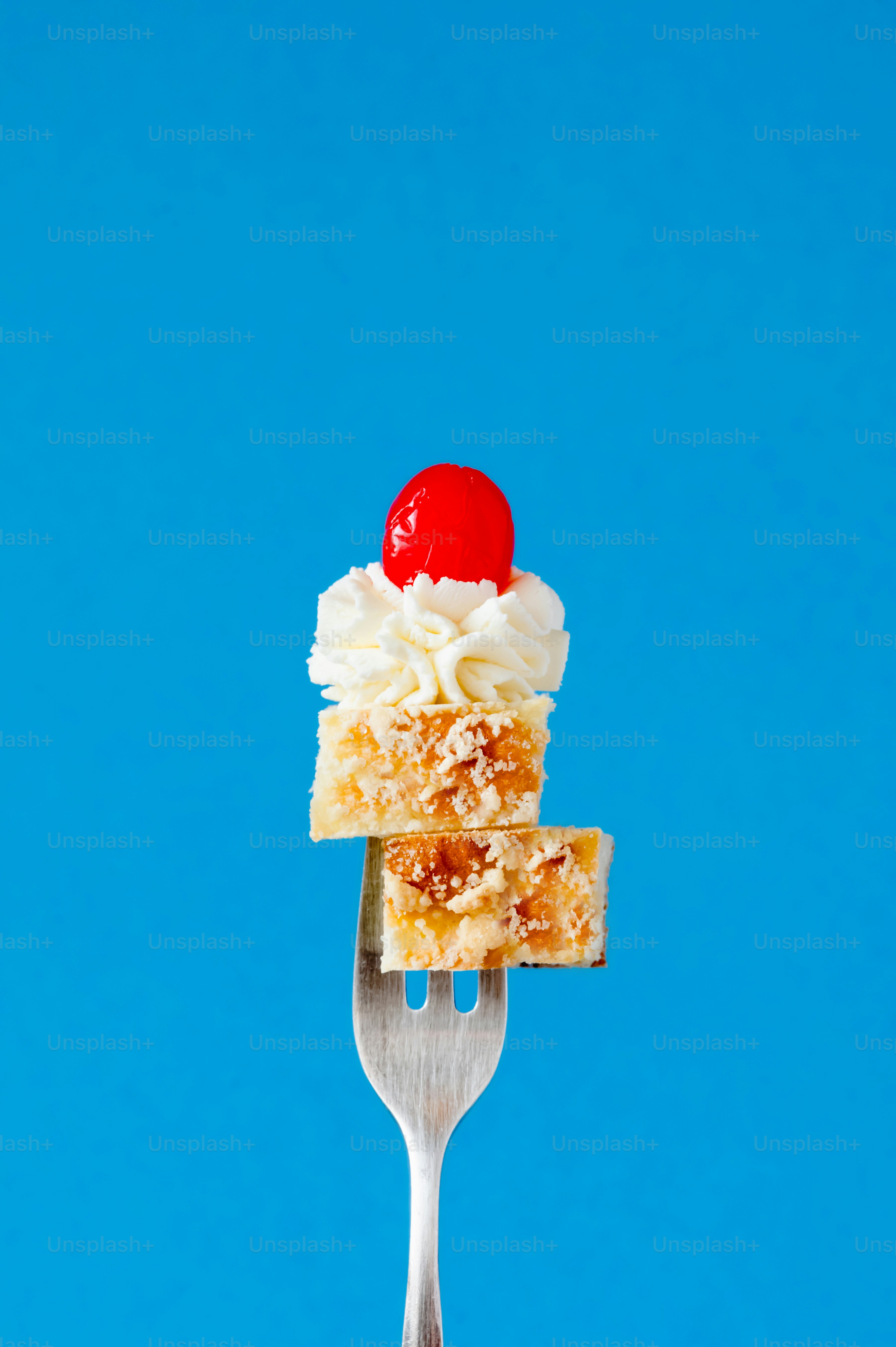 A fork with a piece of cake on top of it