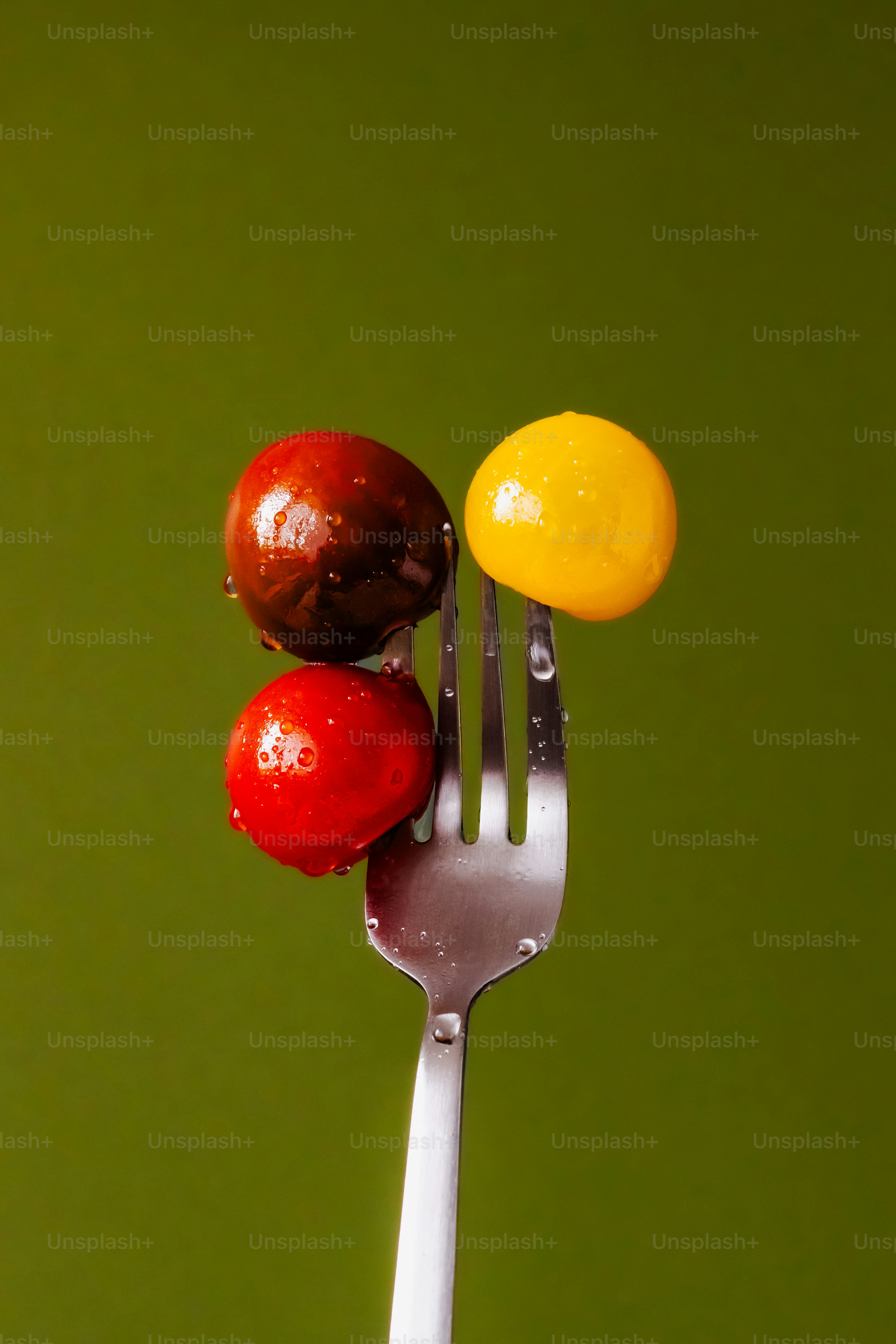 A fork that has some fruit on top of it