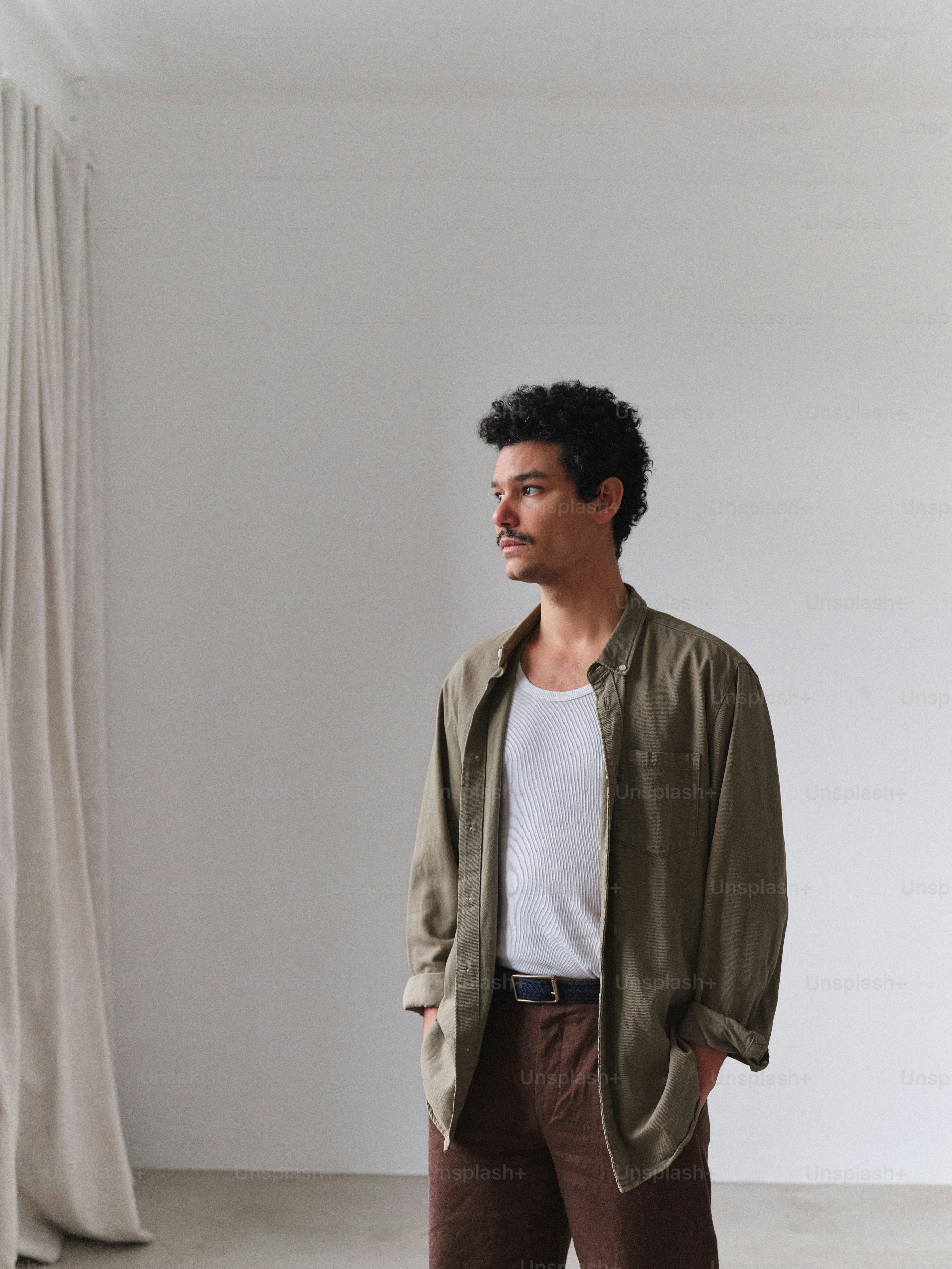 A man standing in front of a curtain