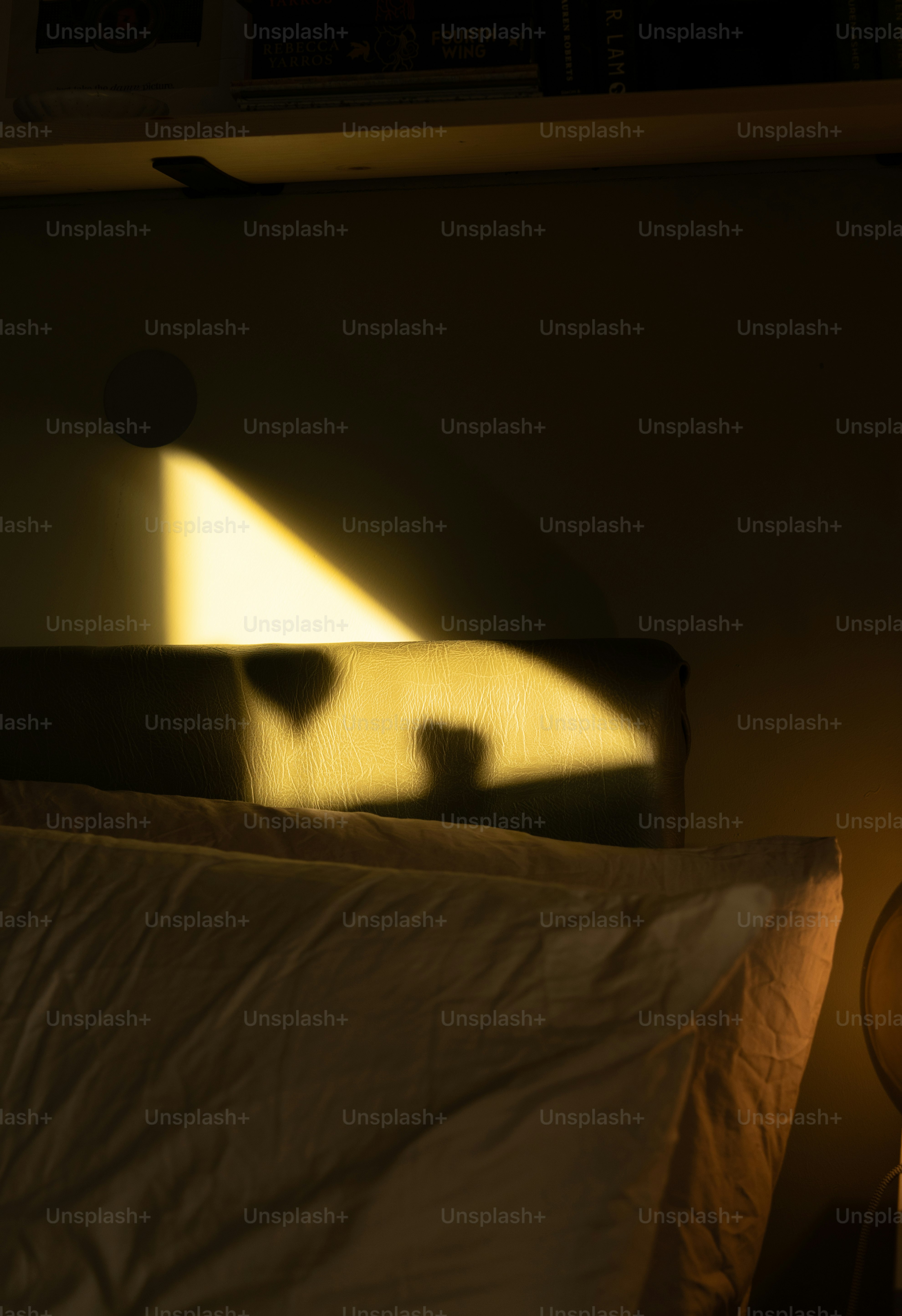 A bedroom with a lamp and a bed