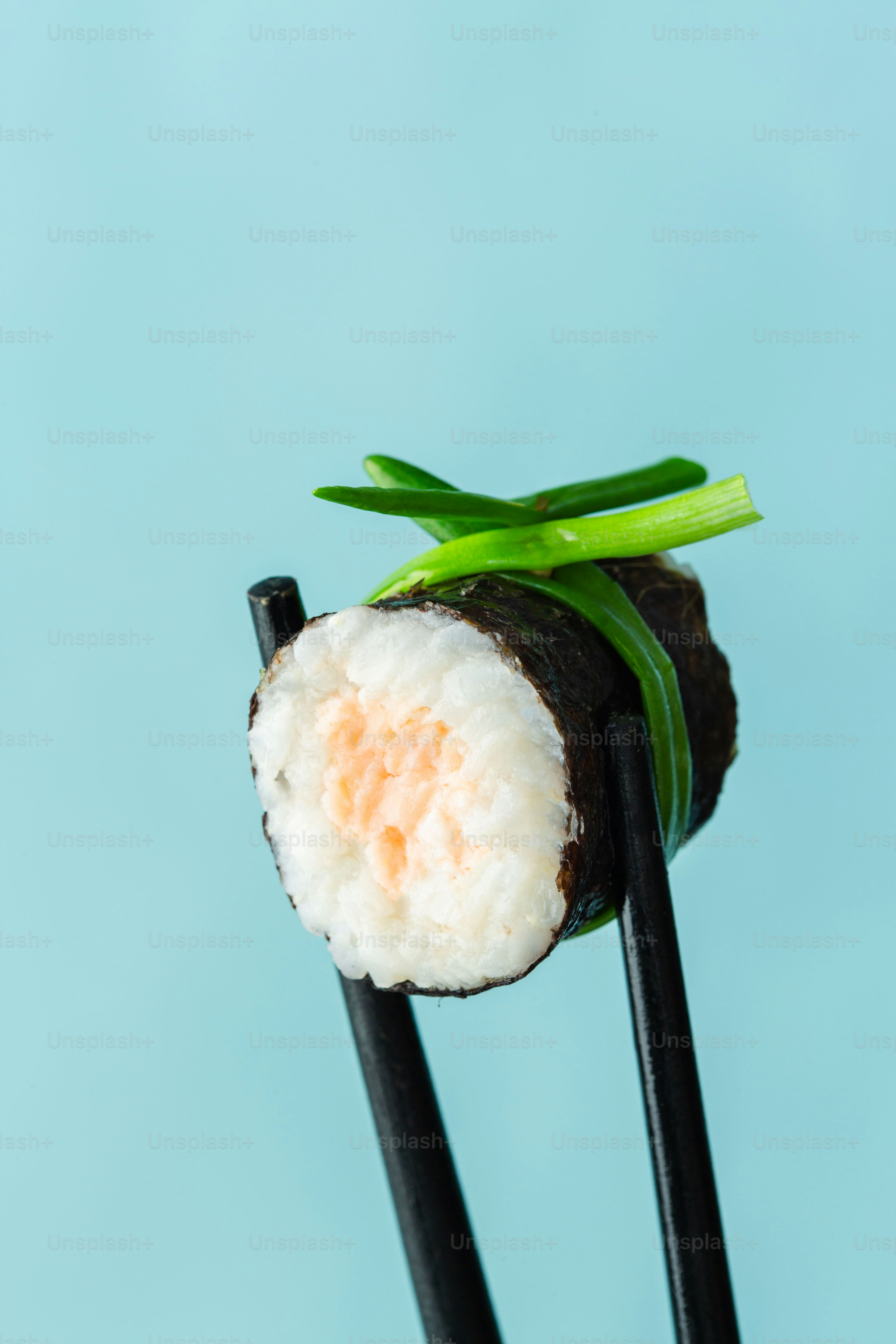 A couple of chopsticks with some food on them