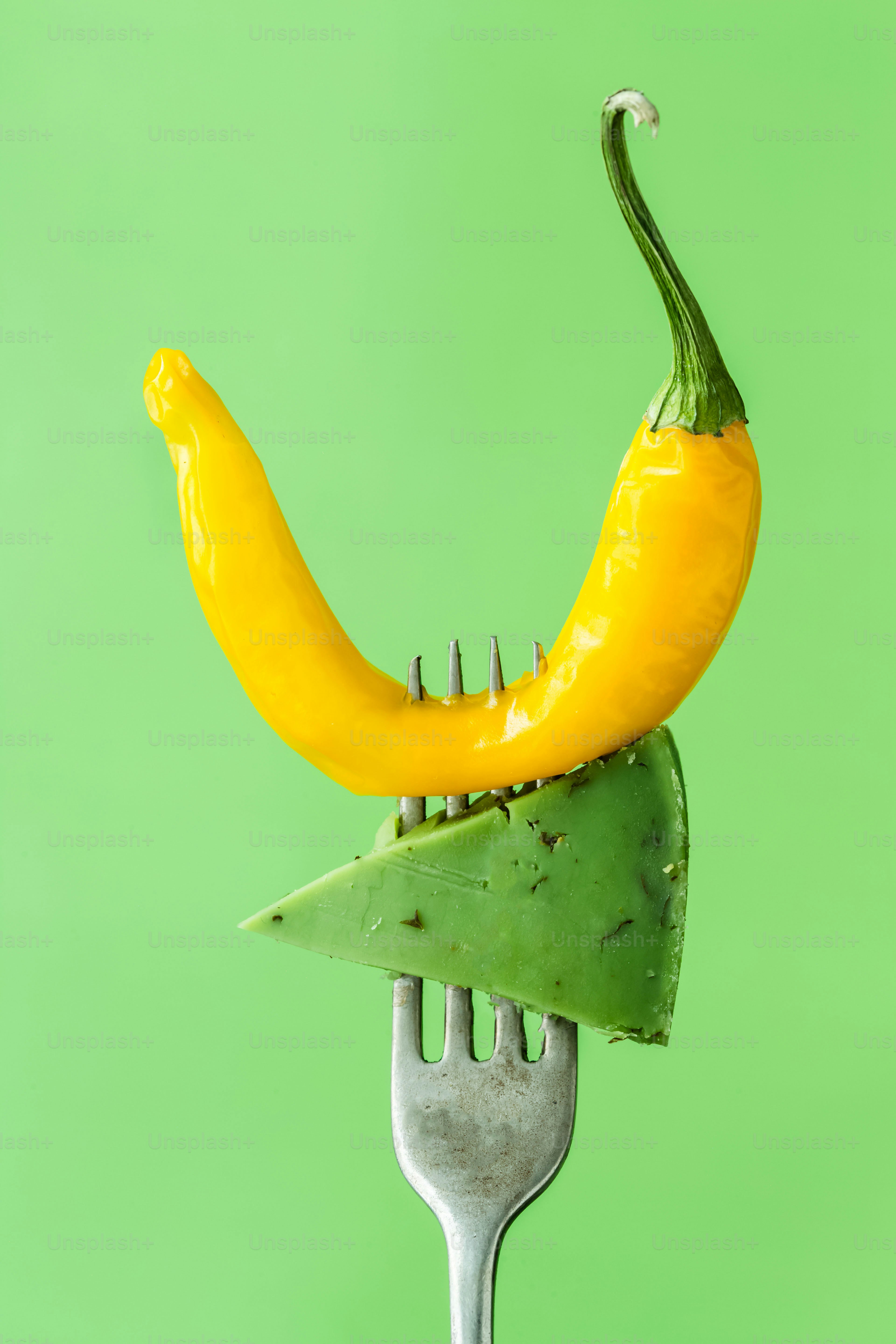 A fork with a yellow pepper on top of it