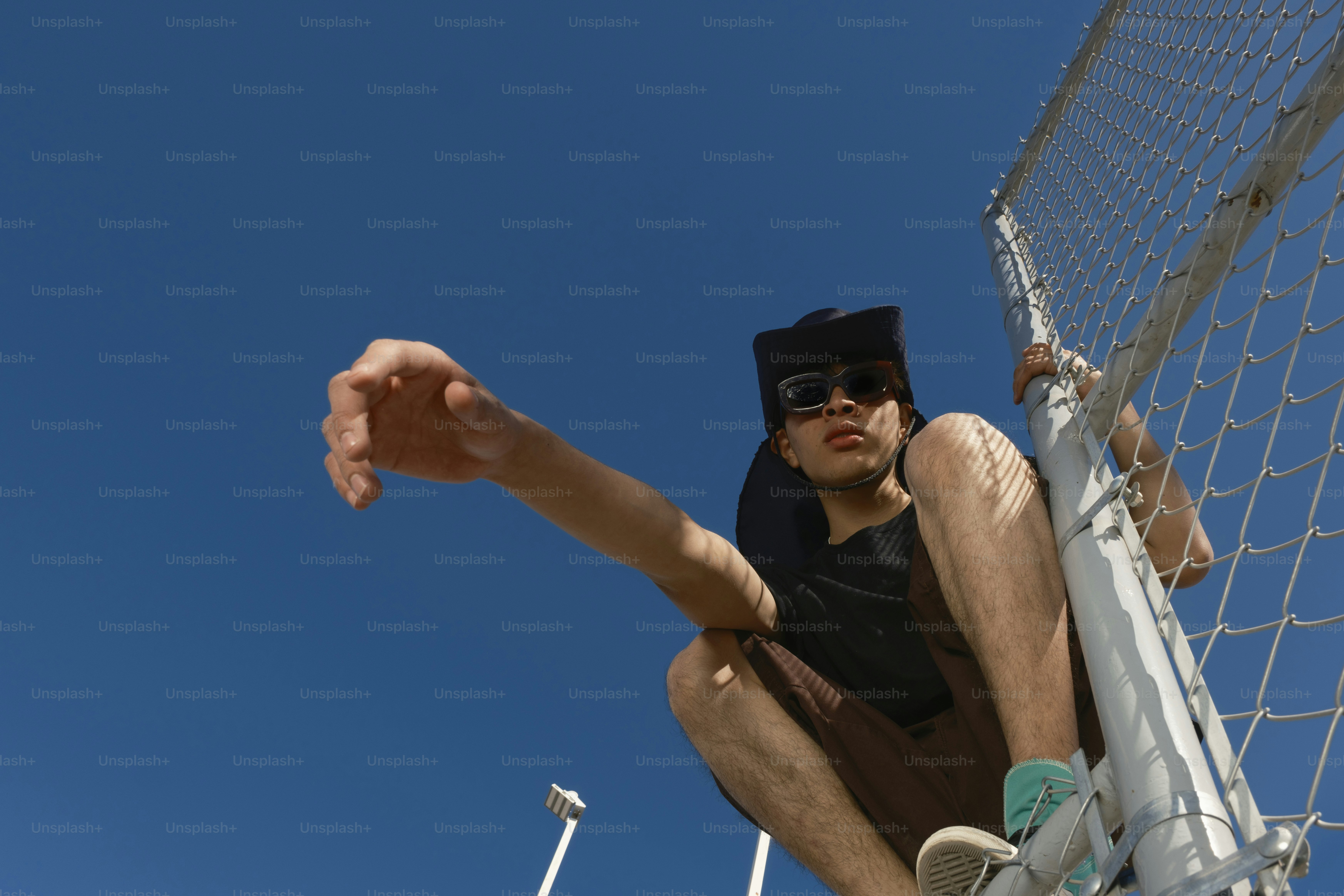 A man sitting on the side of a soccer goal
