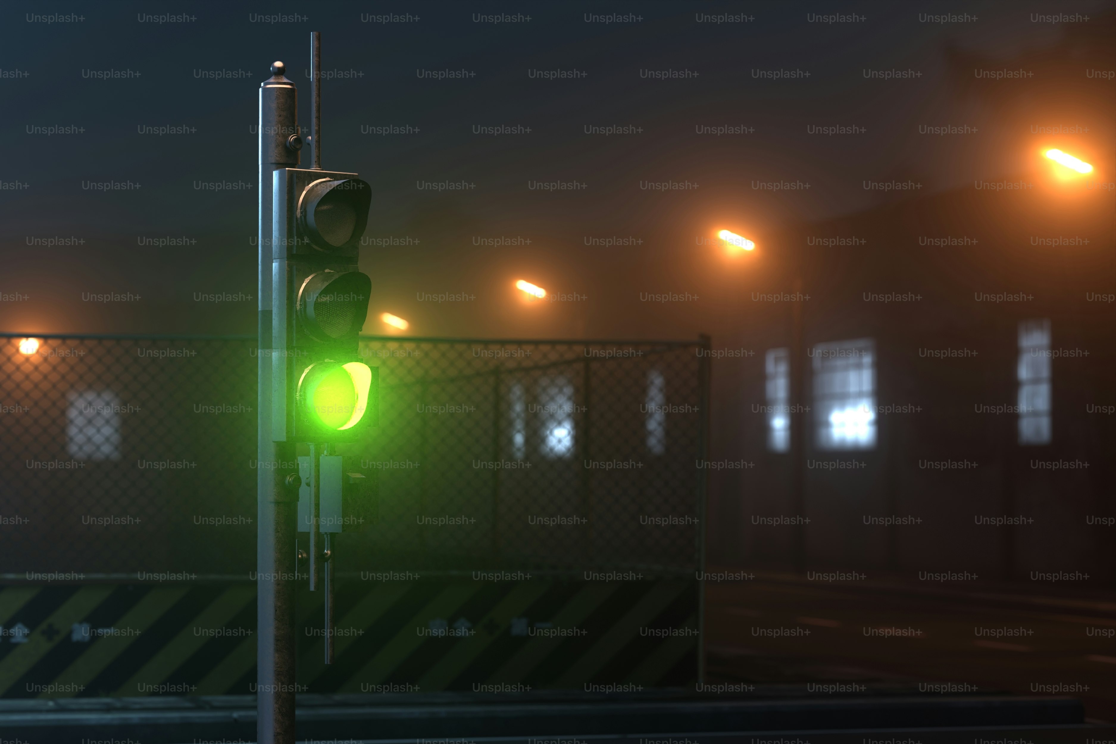 A traffic light on a foggy street at night